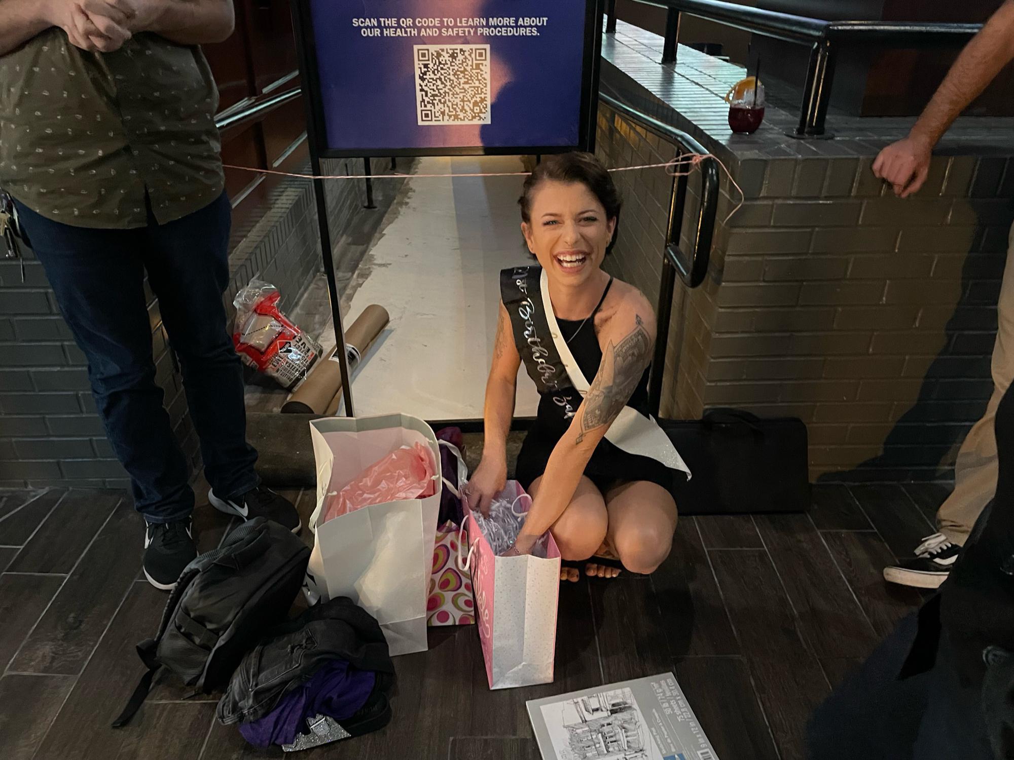 Kristy opening a birthday gift.