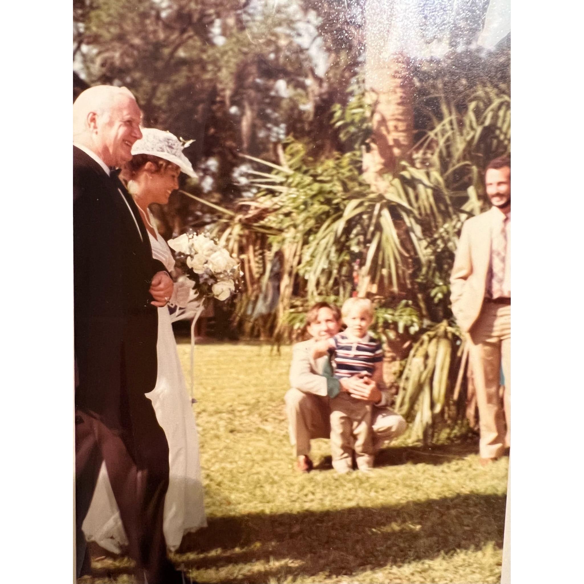 We only just discovered (via this photo) that Carl attended Genevieve's parents' wedding. Pictured here is Genevieve's granddad, Luke, her mom, Joanna (the bride), Carl's dad, Pete, & Carl.