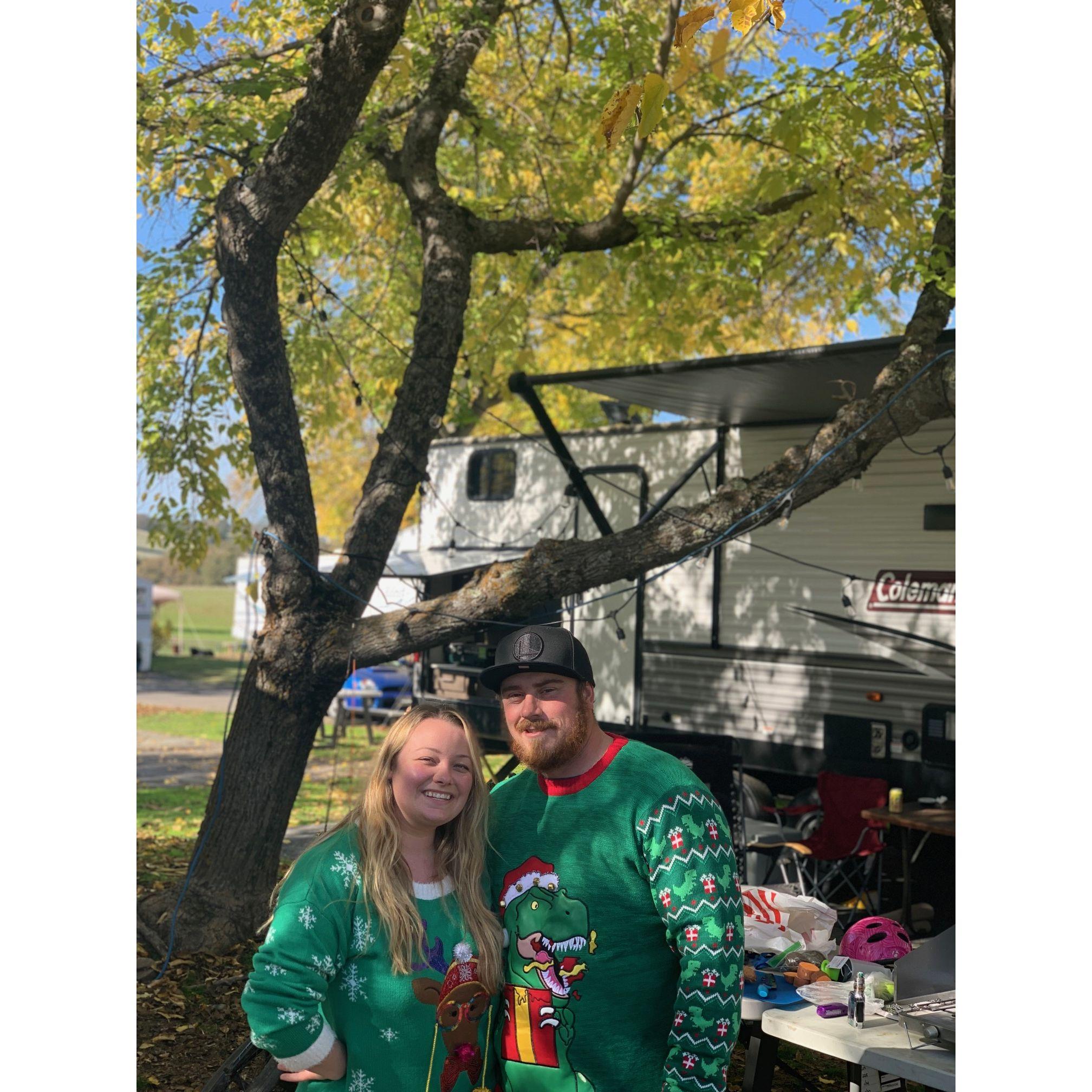 Photo taken during a camping trip with their friends Justin and Ashley (best man and bridesmaid). This trip was for Thanksgiving and they are both wearing their ugly Christmas sweaters.