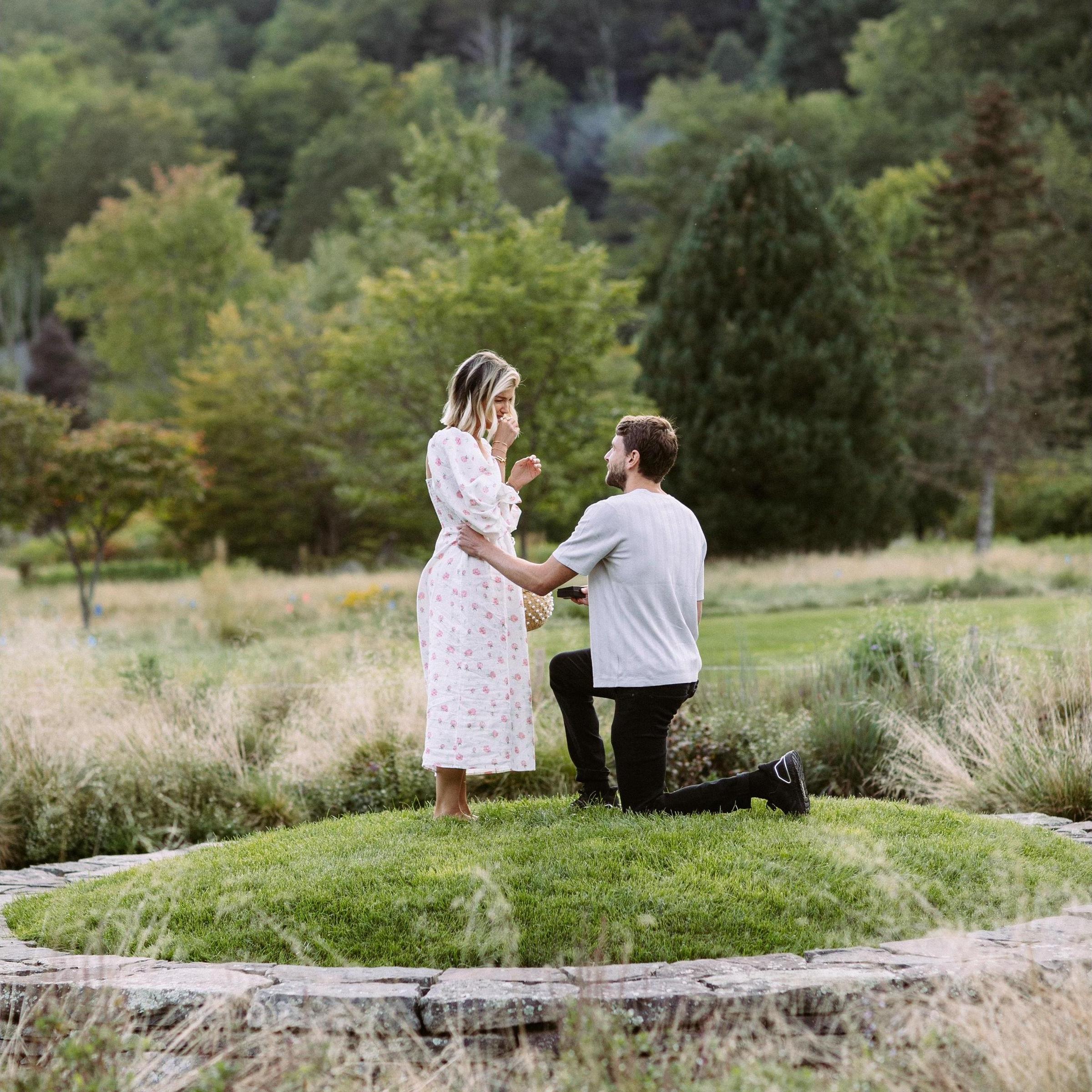 The Engagement upstate in the catskills. Tom had sneaky "bird watcher" professional photographer capture the moment. It was at the arboreteum, inside a labyrinth at sunset. Intimate and perfect.