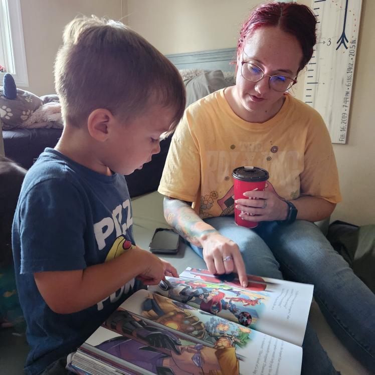 Carissa and Xavier reading about the Avengers!
