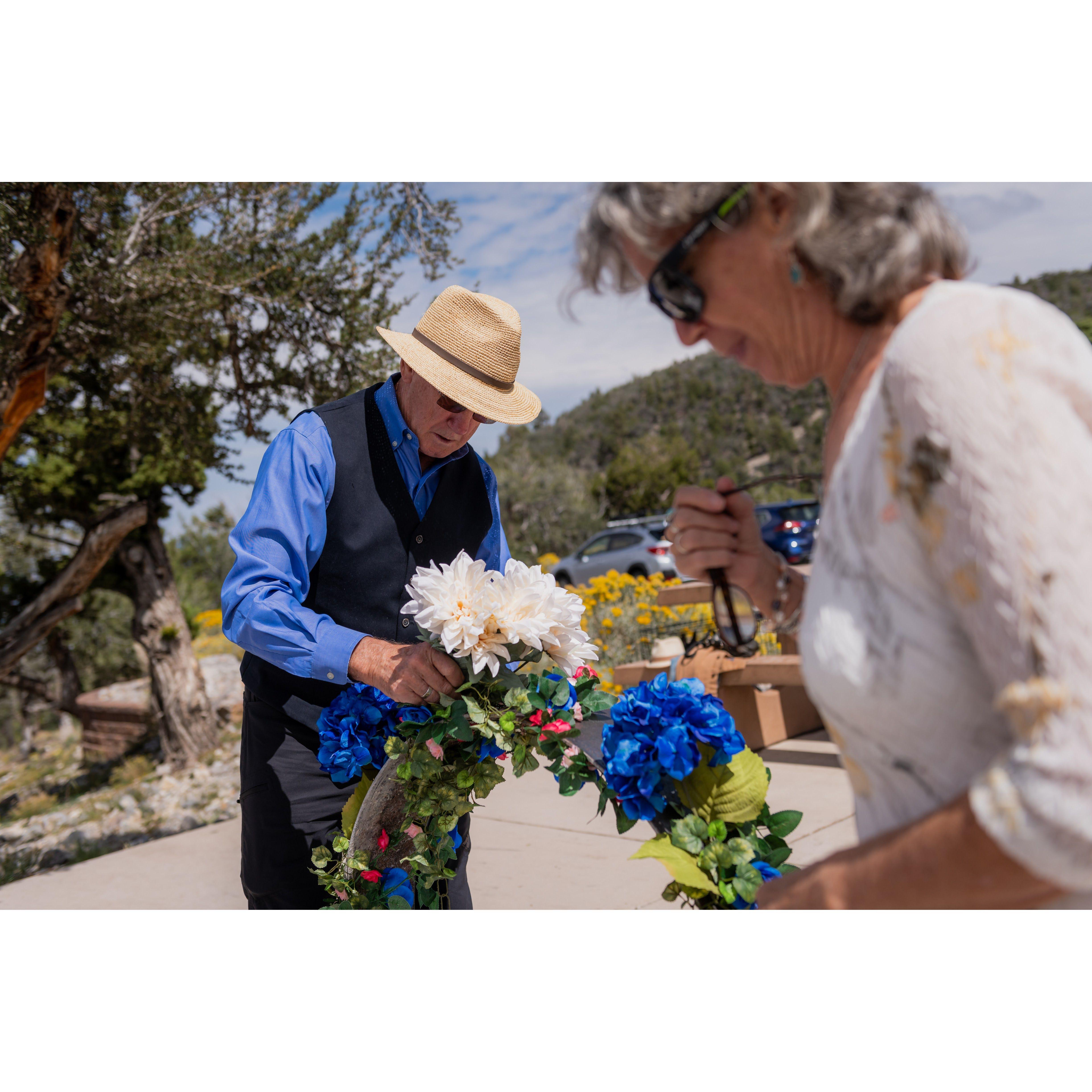 Getting the campsite ready for the wedding was an all-hands-on-deck affair. Sean's dad Richard and mom Anne help set up flowers around the "altar."