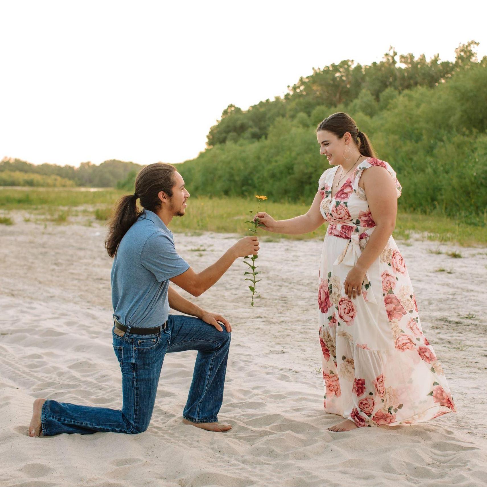 (Engagement Photo) This photo is really special. Since we have been long-distance for almost our whole relationship. This is the first time that Rebecca was able to receive a flower from John Michael!