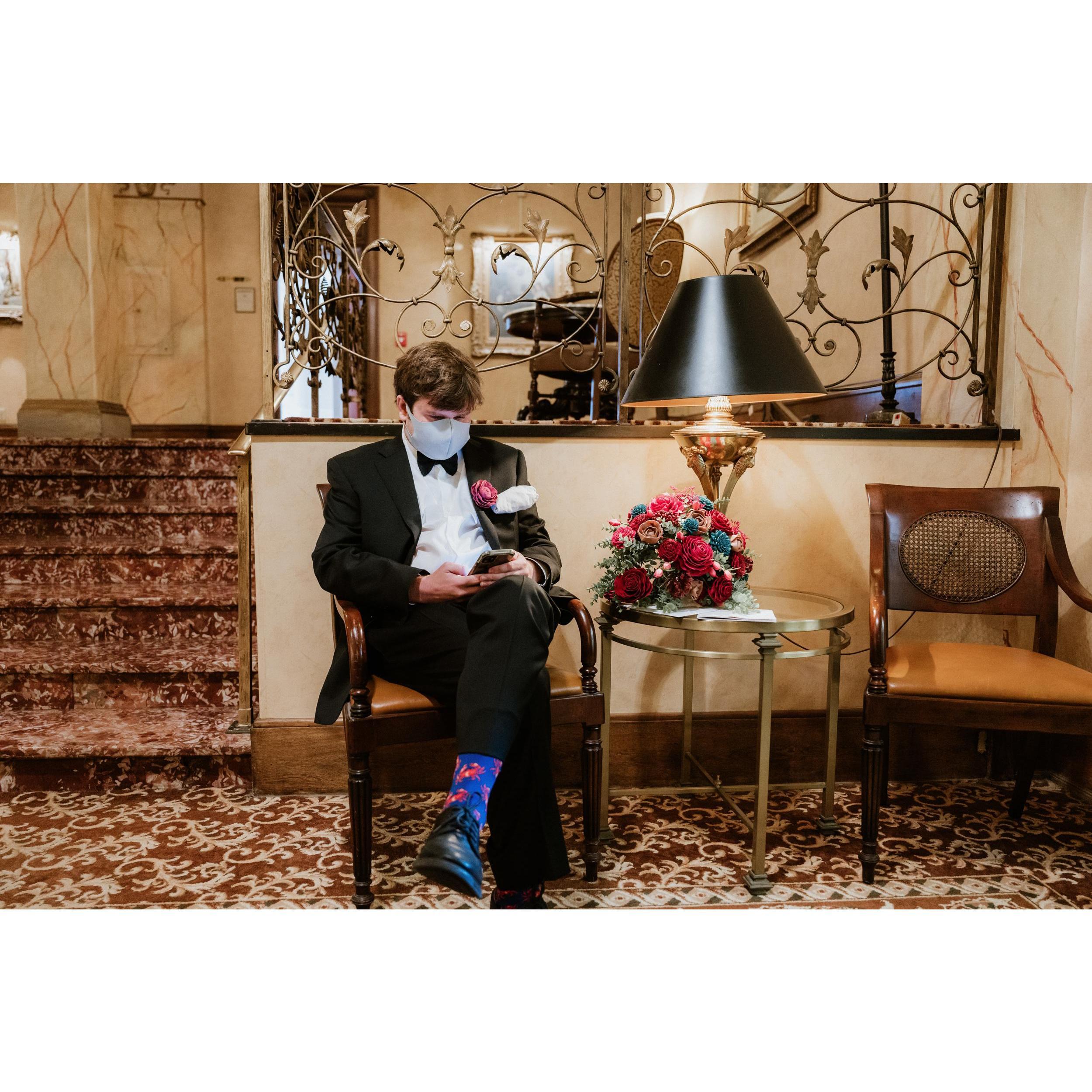 Zach waiting for Margaret at the Pfister Hotel. He is wearing a hanky from Margaret's dad, Tom, in his coat pocket.