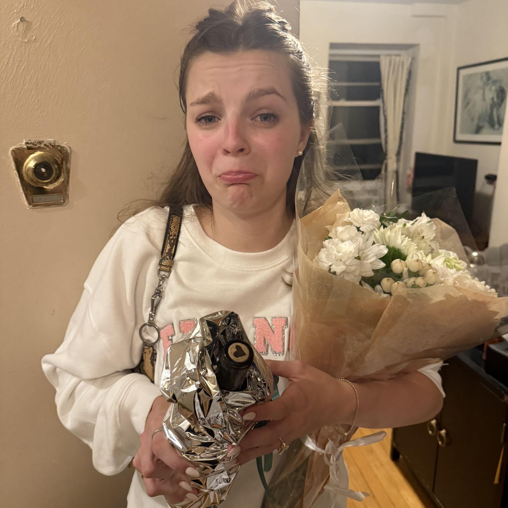 Zoe overwhelmed from the celebration, enjoying a cute wine gift from the neighbors