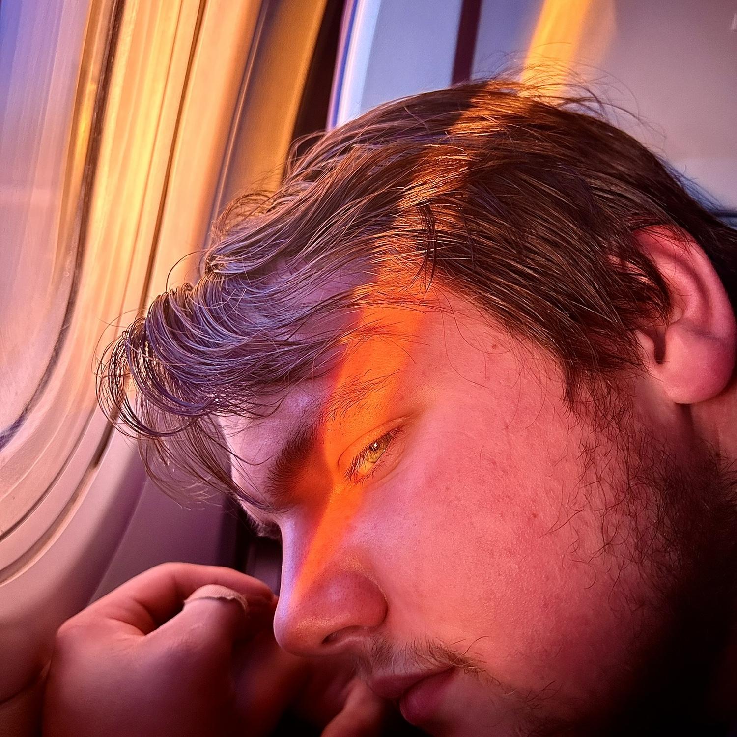This was a photo we took from our first trip together. He had never been on a plane and was peeking over to see the sun.