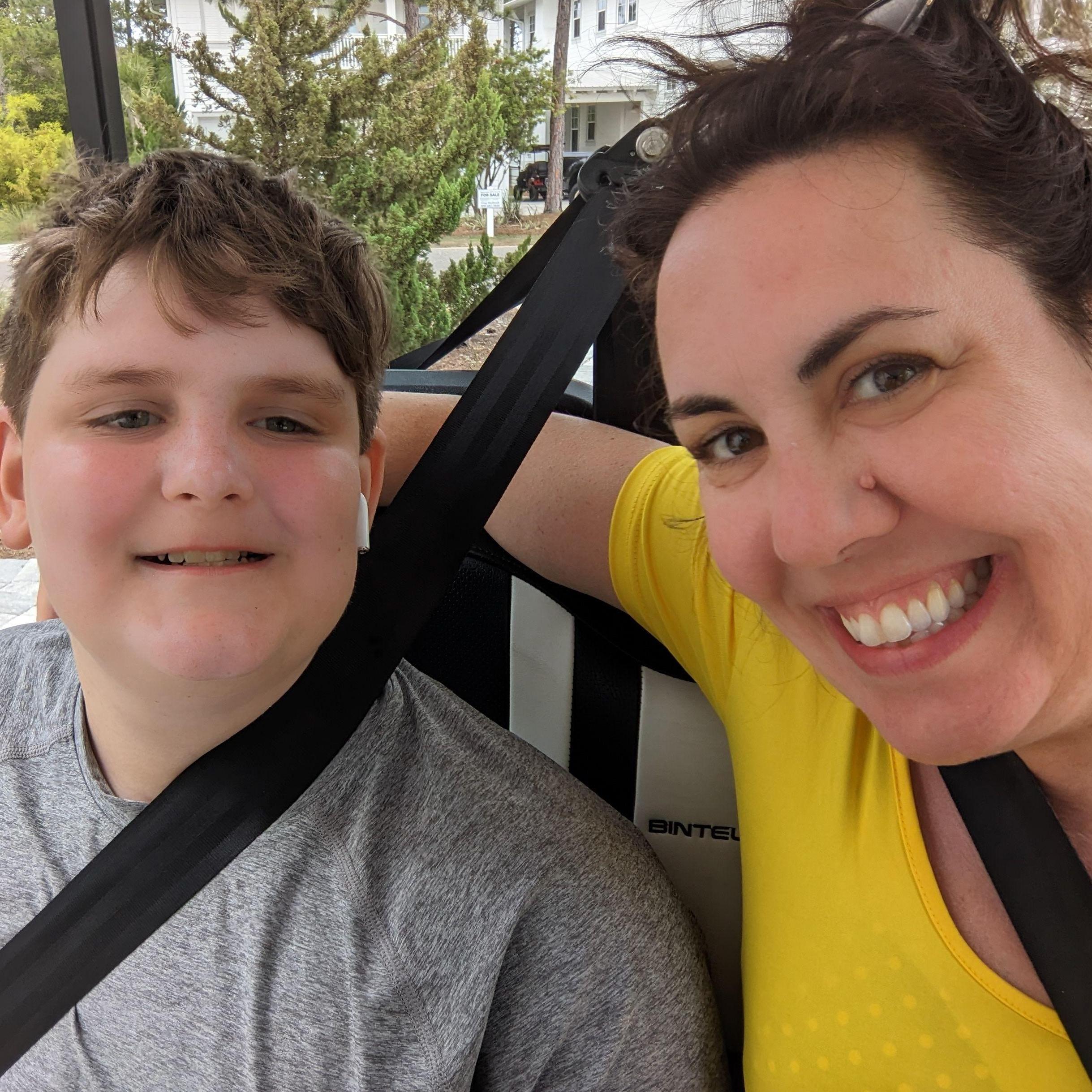 Jack and I hitching a ride on the golf  cart during family trip to Florida