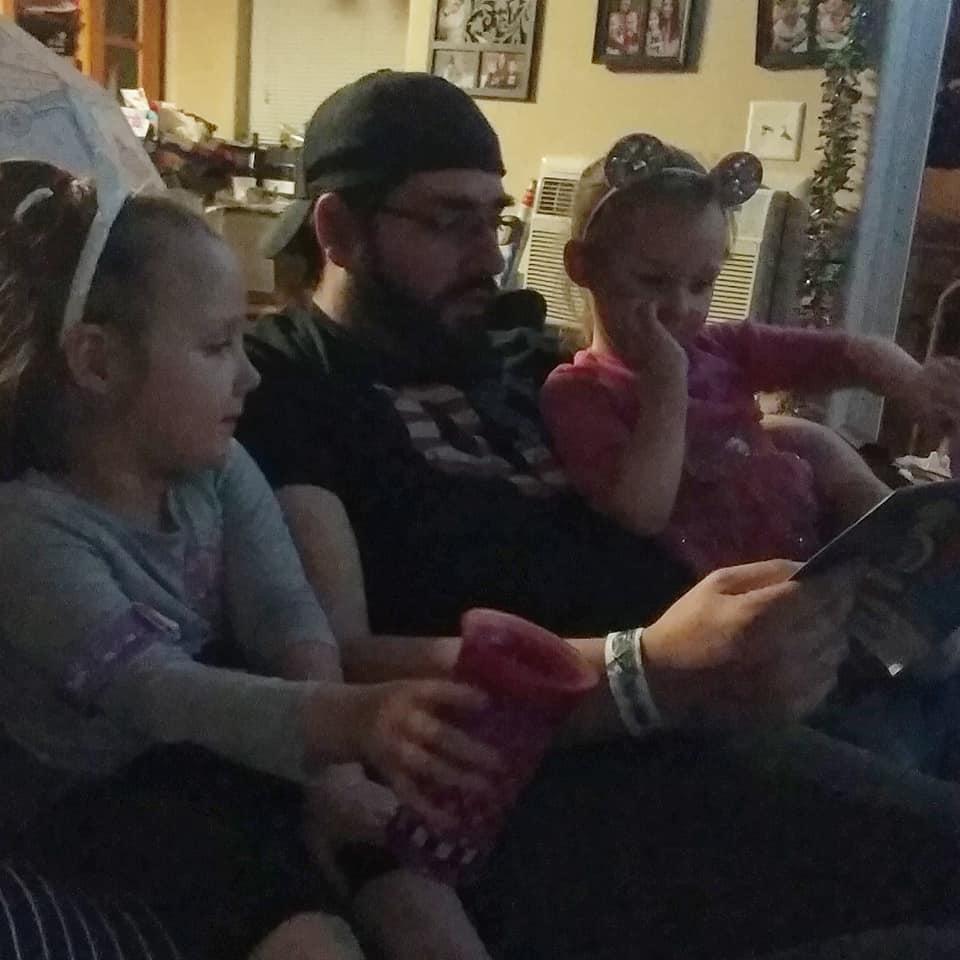 Reading kid car books to the girls.