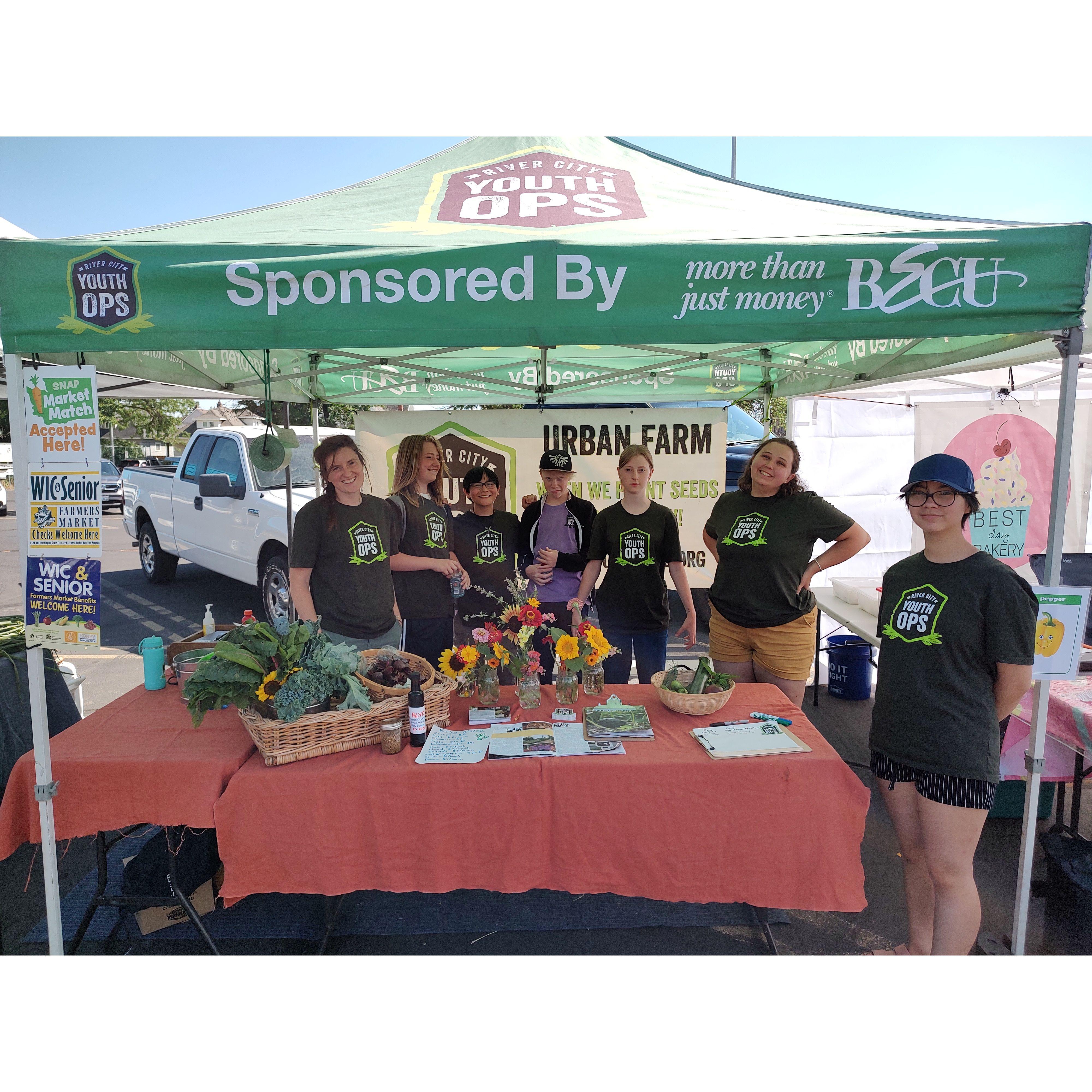 Over Summer 2022, we both worked for River City Youth Ops, a Spokane nonprofit focused on urban gardening and job training for local youth. I took this picture of Ellie and the crew at the farmer's market we worked at every Friday. 08/05/22