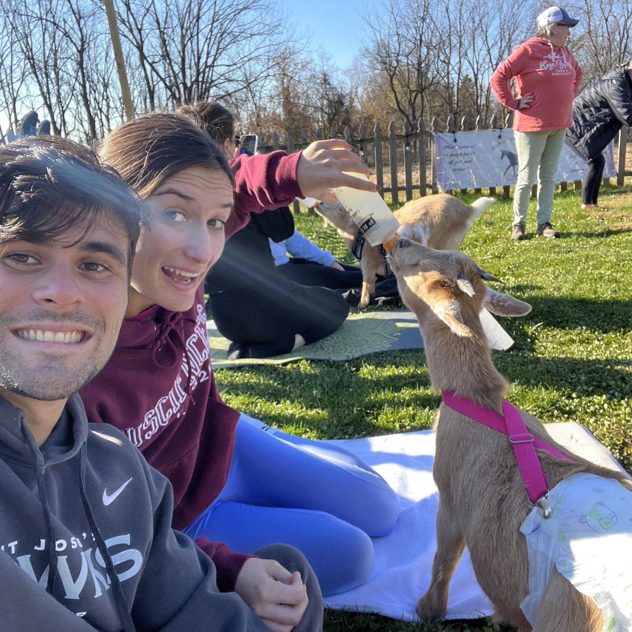 James and Charlotte feeding a baby goat before goat yoga!