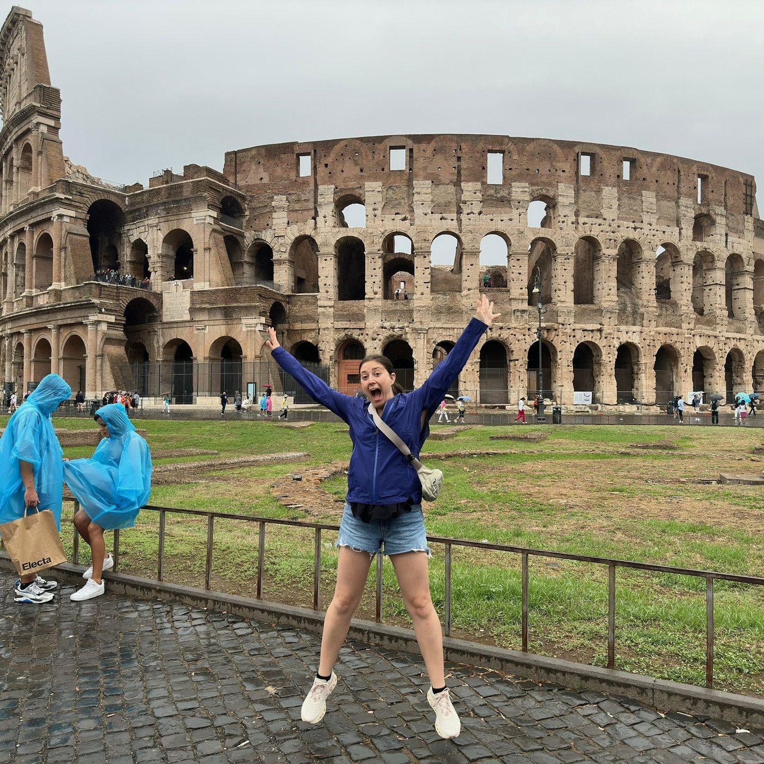 Caught in the wild: L leaping in front of the Colosseum like she owns ancient Rome. Main character energy? Always.