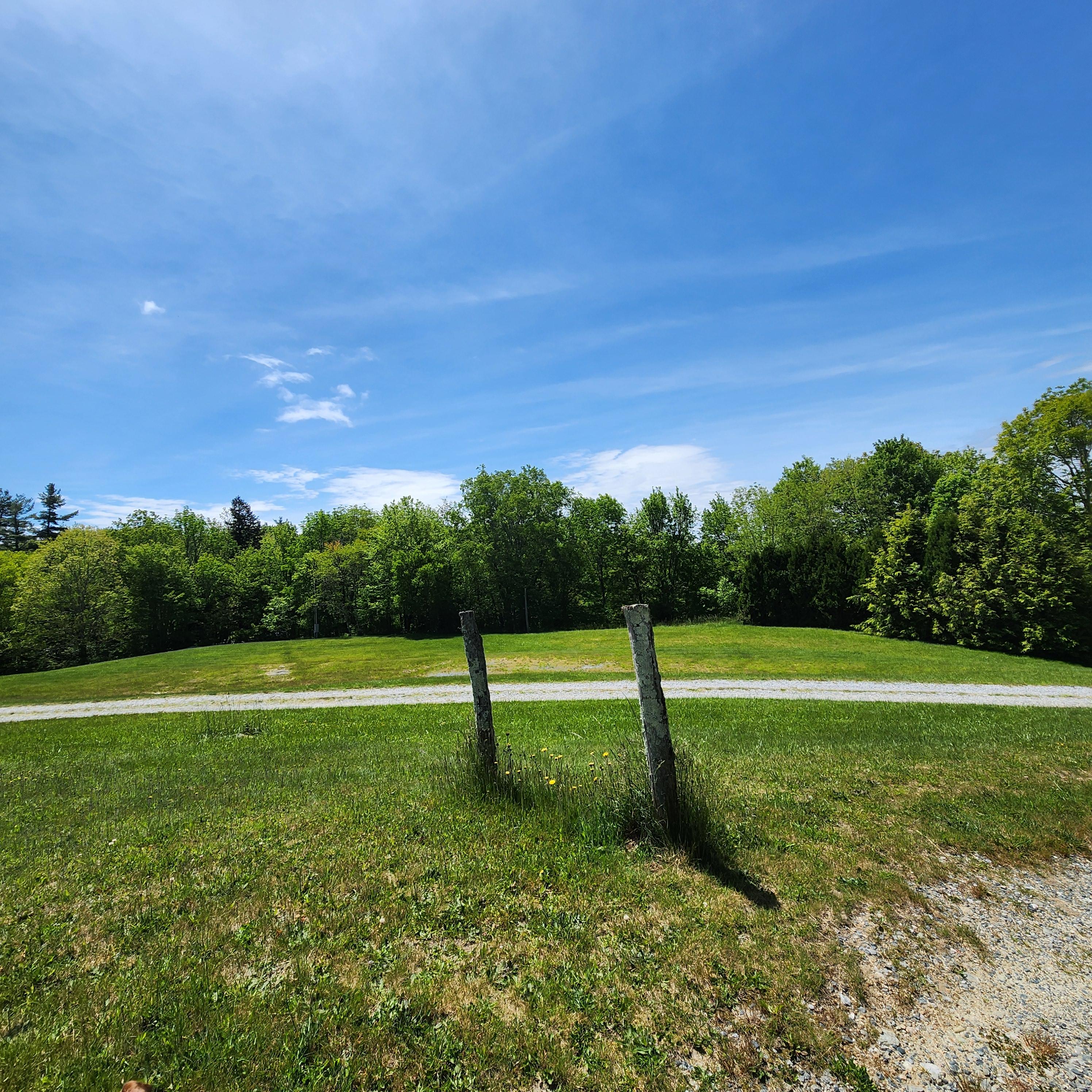 Then we’ll go down a slight hill here toward the reception tent, which will be in the bare-looking spot in the grass in the far background.