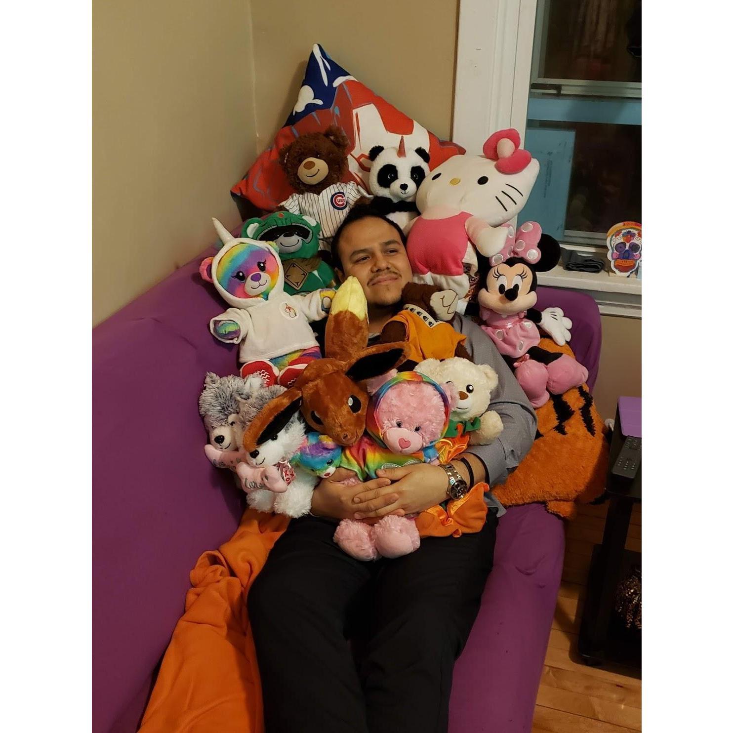 Julio covered in stuffed animals