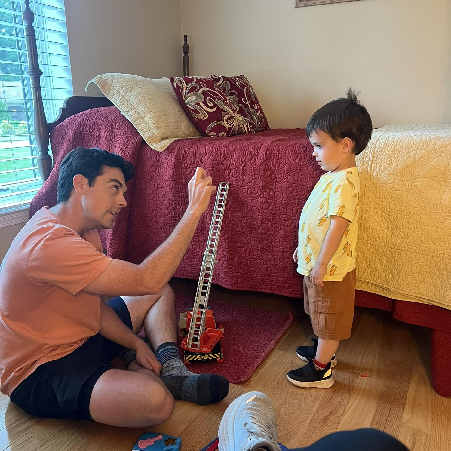 Zach talking to Dylan (bride’s nephew) about either excavators, fire trucks, or skid steer’s!
