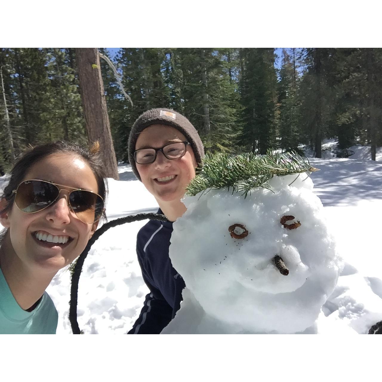 Brandon teaching Megan how to make an authentic snowman