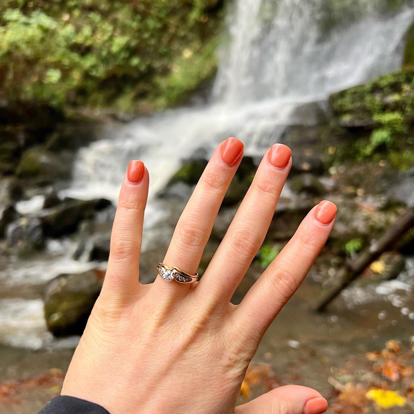 John proposed with the engagement and wedding ring that his father (Michael) gave to his mother (Nancy). The center stone was originally John's grandmother's (Joanne).