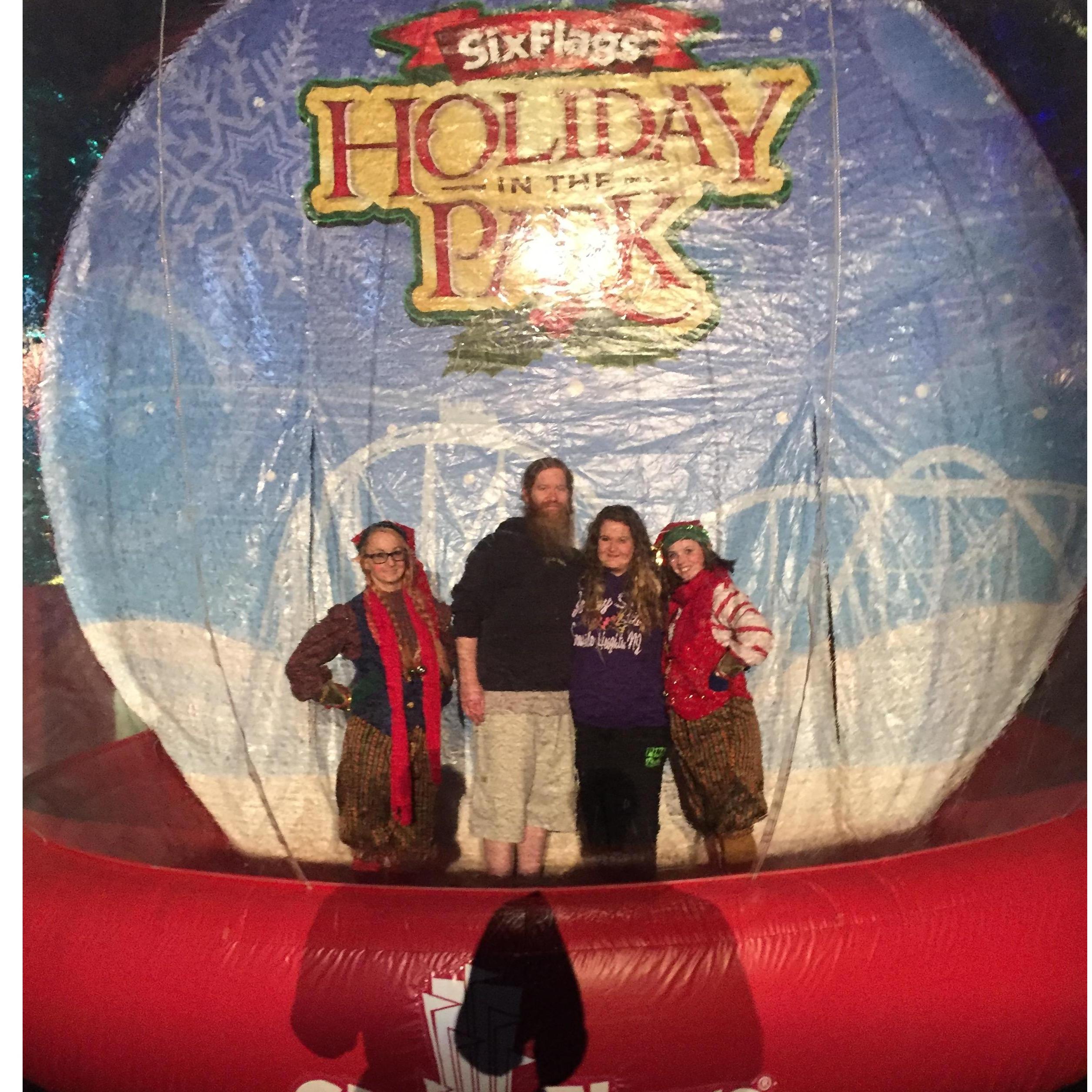 At Six Flags in the freezing cold, with two elves posing in a giant snow globe. Nothing weird here because it's pretty much our norm.