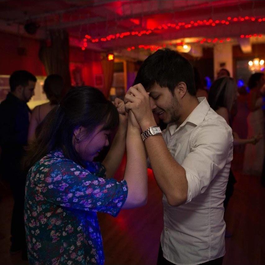 This was the first of many weddings we attended as a couple! Here's Bryan teaching Sam some salsa moves during the wedding's dance party.
