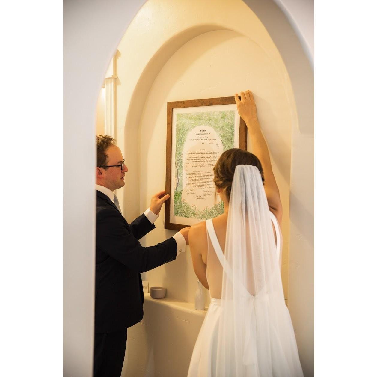 Steve & Rachel hanging the Ketubah in their home