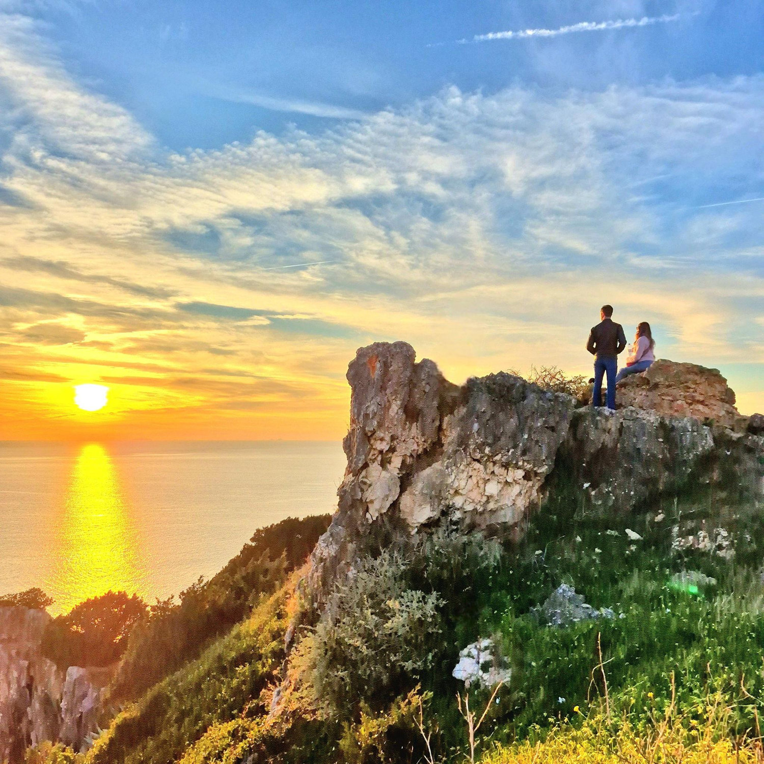 Last sunset of 2024. That's us sitting on the rocks to the right. (photo credit to Monica) Nazare, Portugal - December 2024