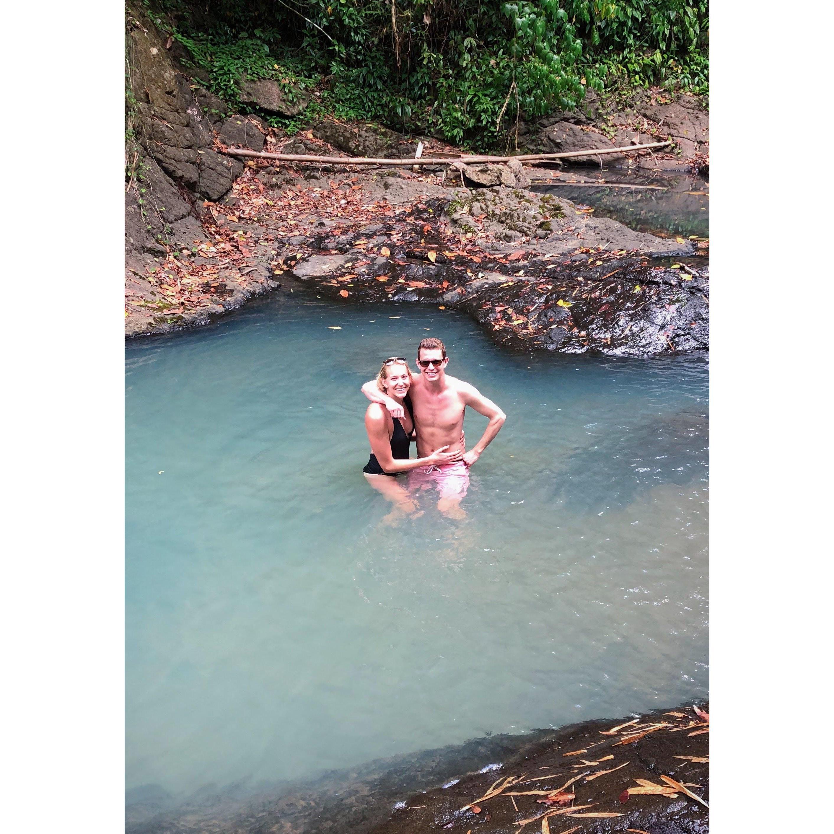 dipping in at the base of a waterfall in Saint Lucia with the Baumann's