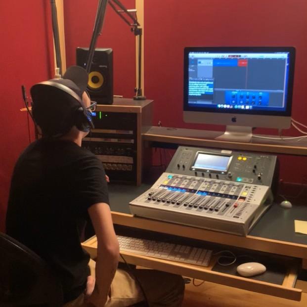 Emily in one of the recording studios at school working on an Audio Production project