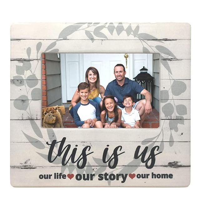BANBERRY DESIGNS This is Us Picture Frame - Family Photo Plaque with Farmhouse Style Theme - Whitewashed Barnboard Background with Sage Green Wreath - Our Life Our Story Our Home - 4 X 6 Picture Open