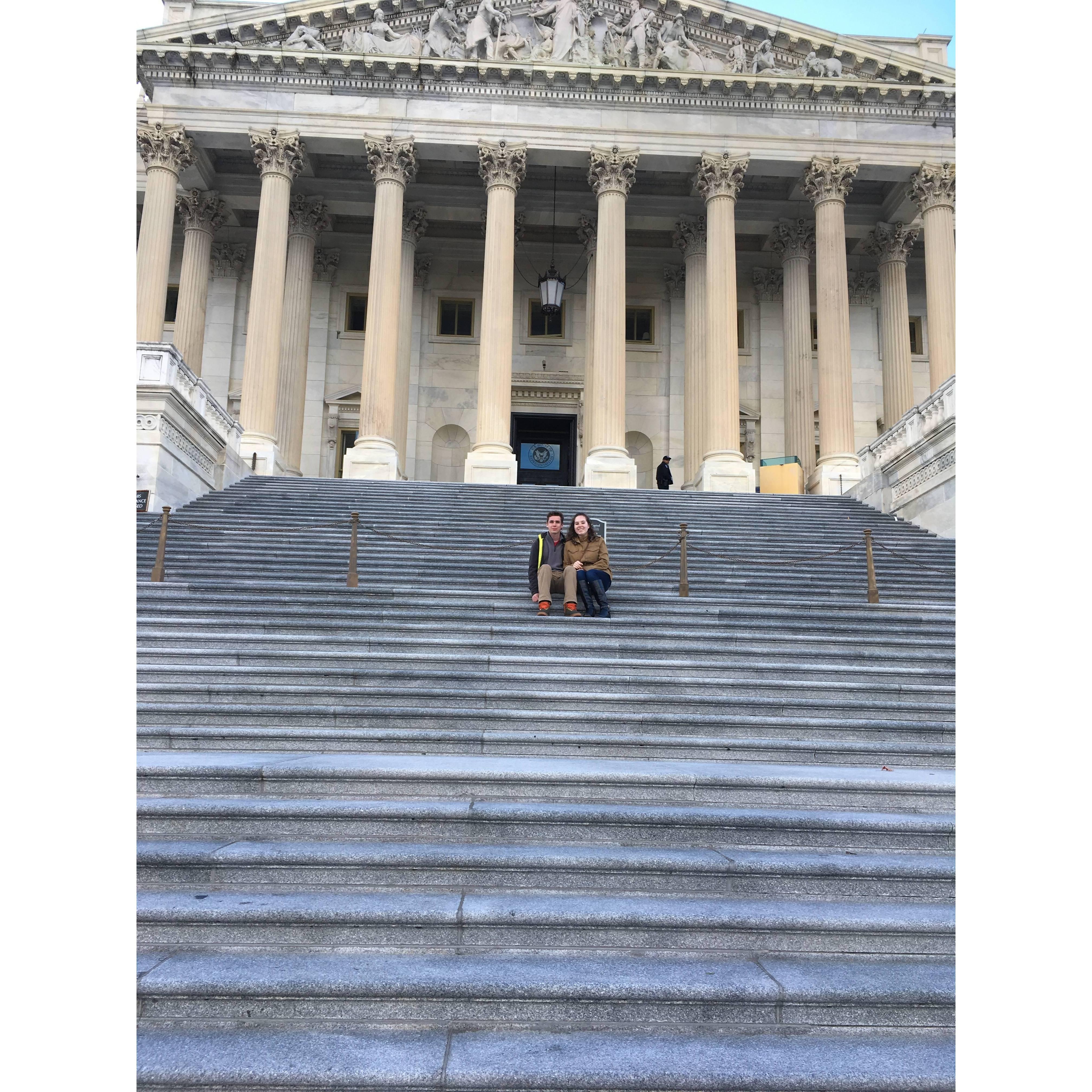 Olivia and Vince sitting on the steps of the U.S. Capitol.