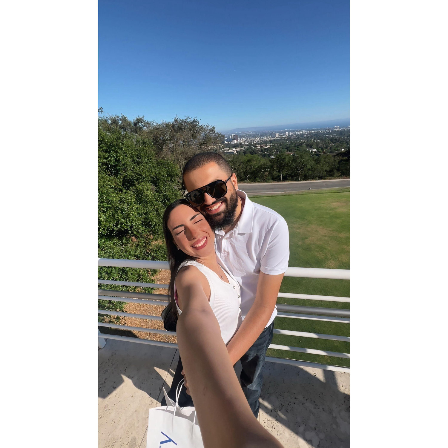 “Sunshine, city views, and two very happy hearts.”