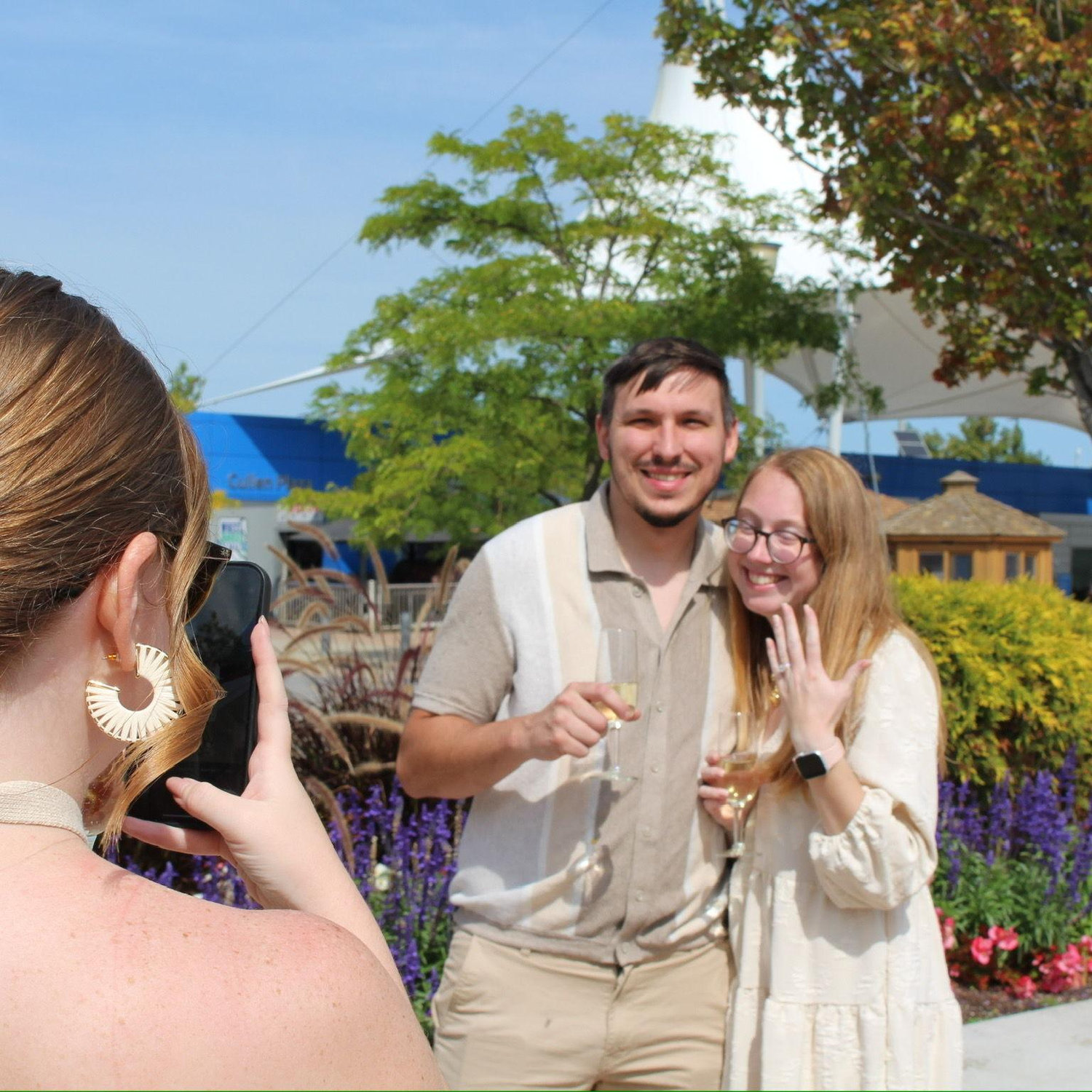 Kennedy's sister, Riley, taking a picture of the newly engaged couple. If you ask her, she was their "Day of Coordinator" for the engagement!