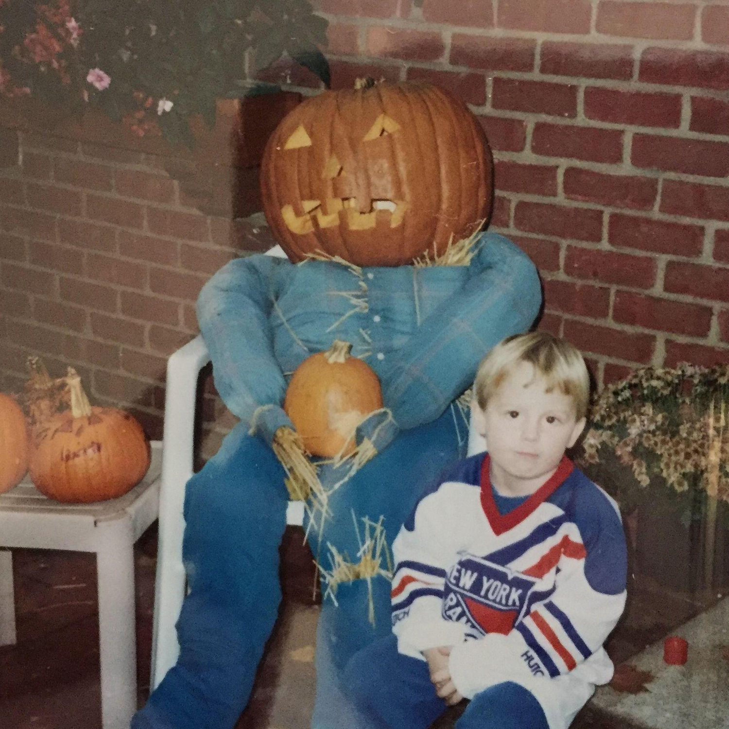 Posing with a pumpkin man for Halloween in the early 90s.