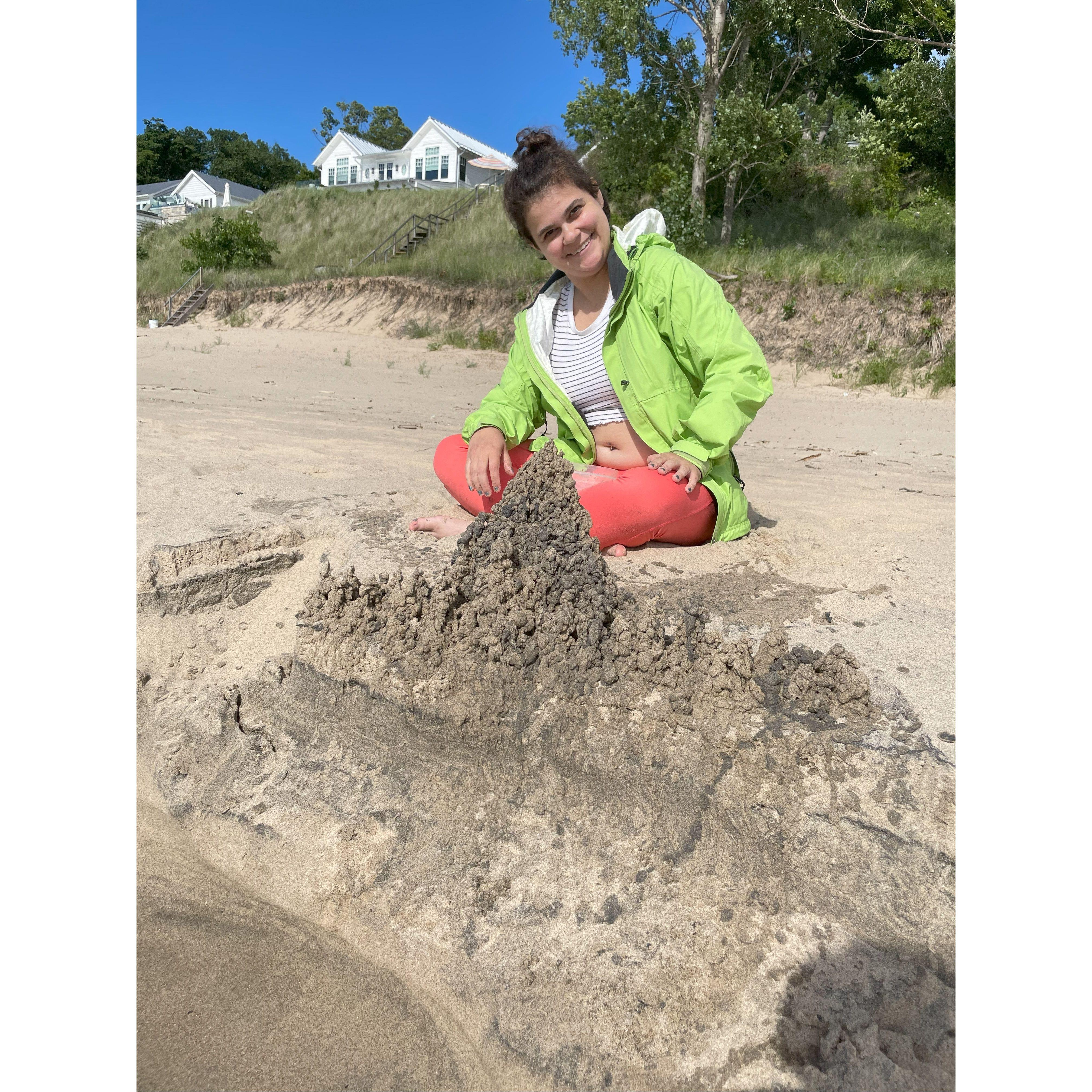 Sarah is very proud of her sand castle while showing Jayden around Holland, Michigan.