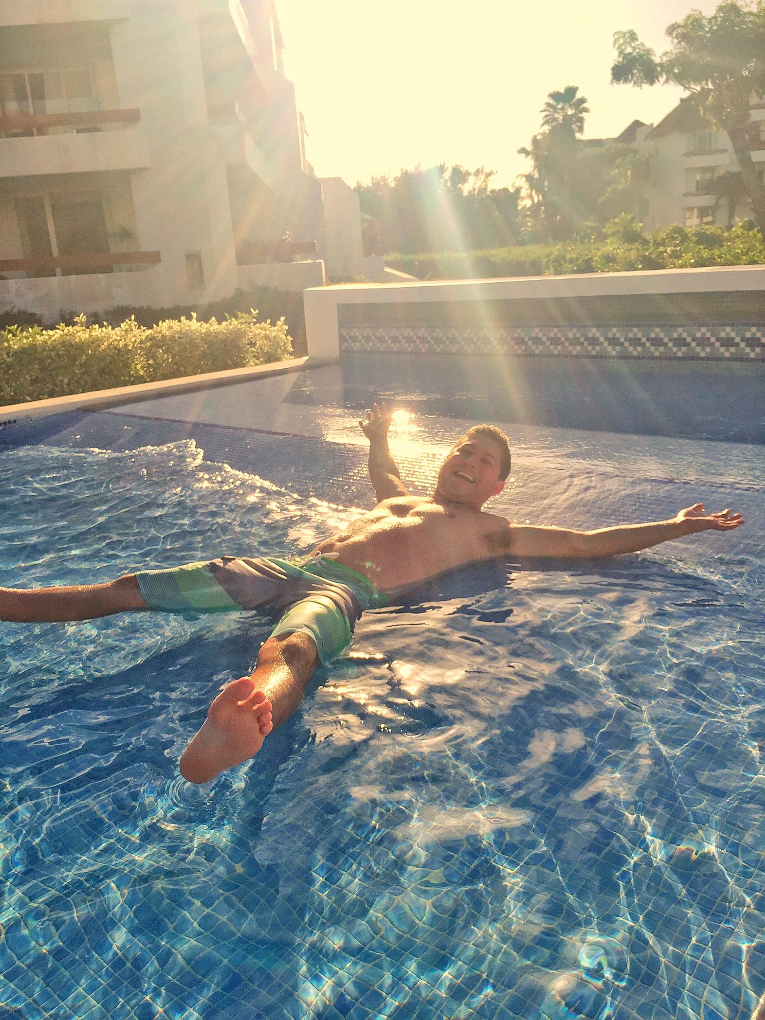 Dustin soaking up the sun at the Pool in Residencias Reef