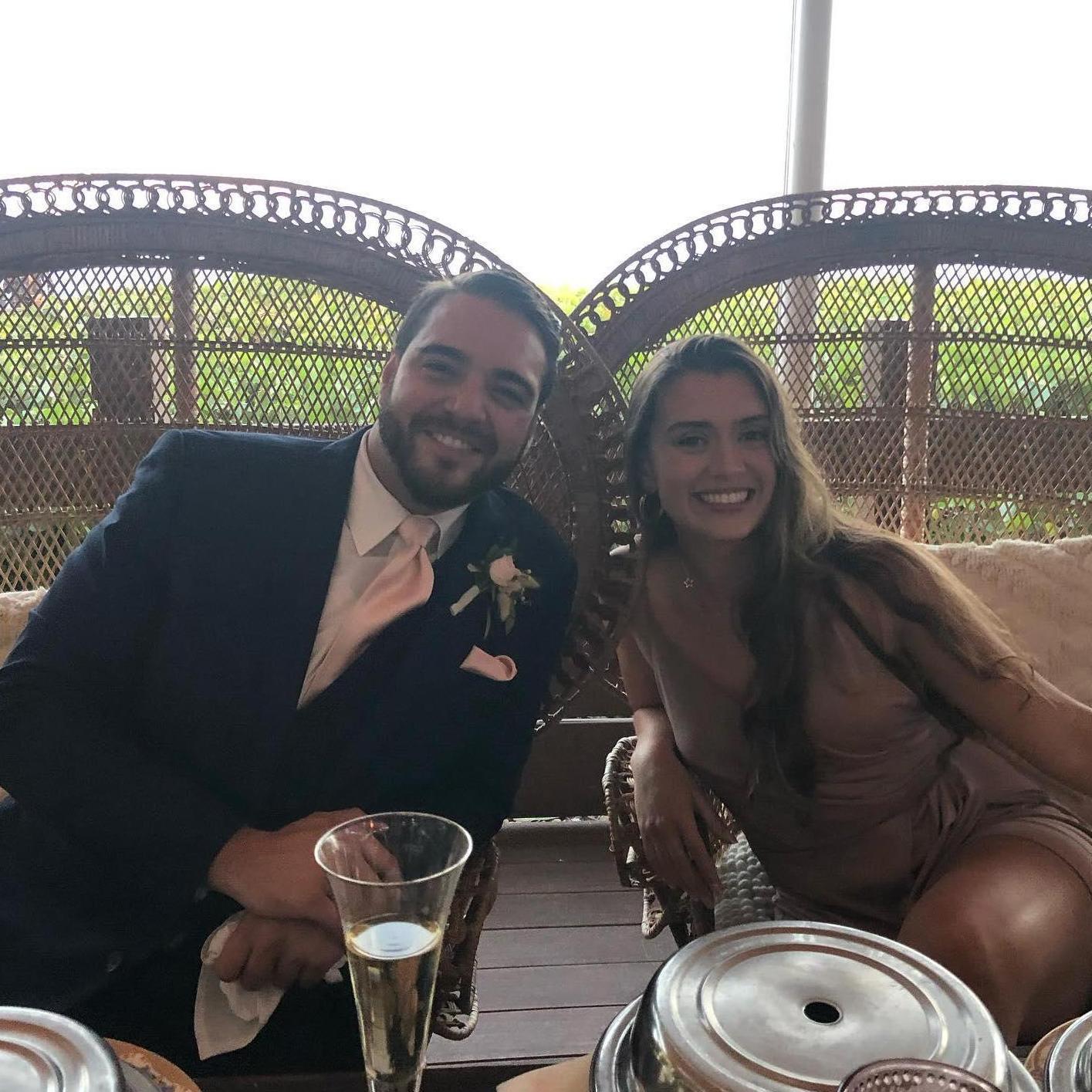At their first date at TJ's sister's wedding, TJ asked Rosie to take a quick photo in the bride and groom's chairs