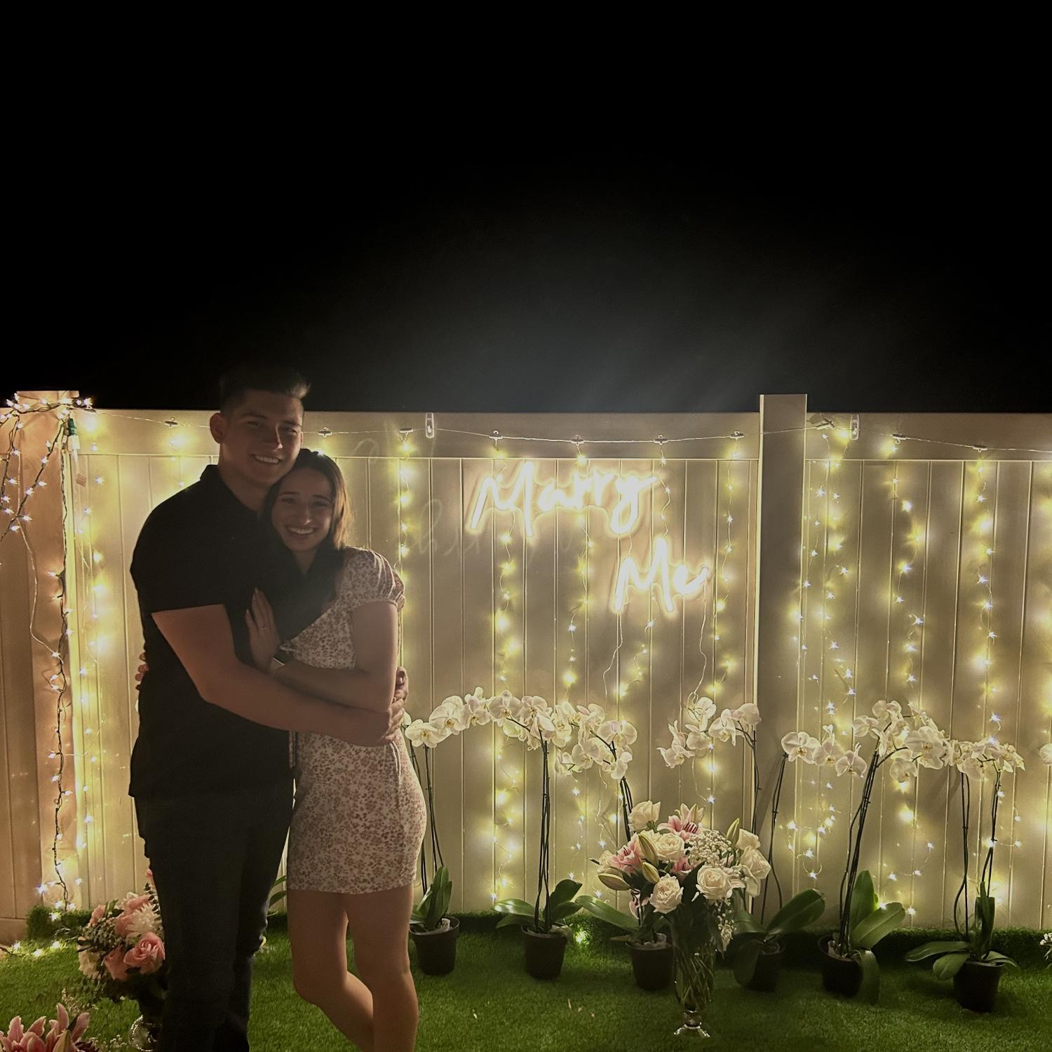 Daniel had Dani out of the house for a couple of hours to put together their engagement in their back patio to surprise her.