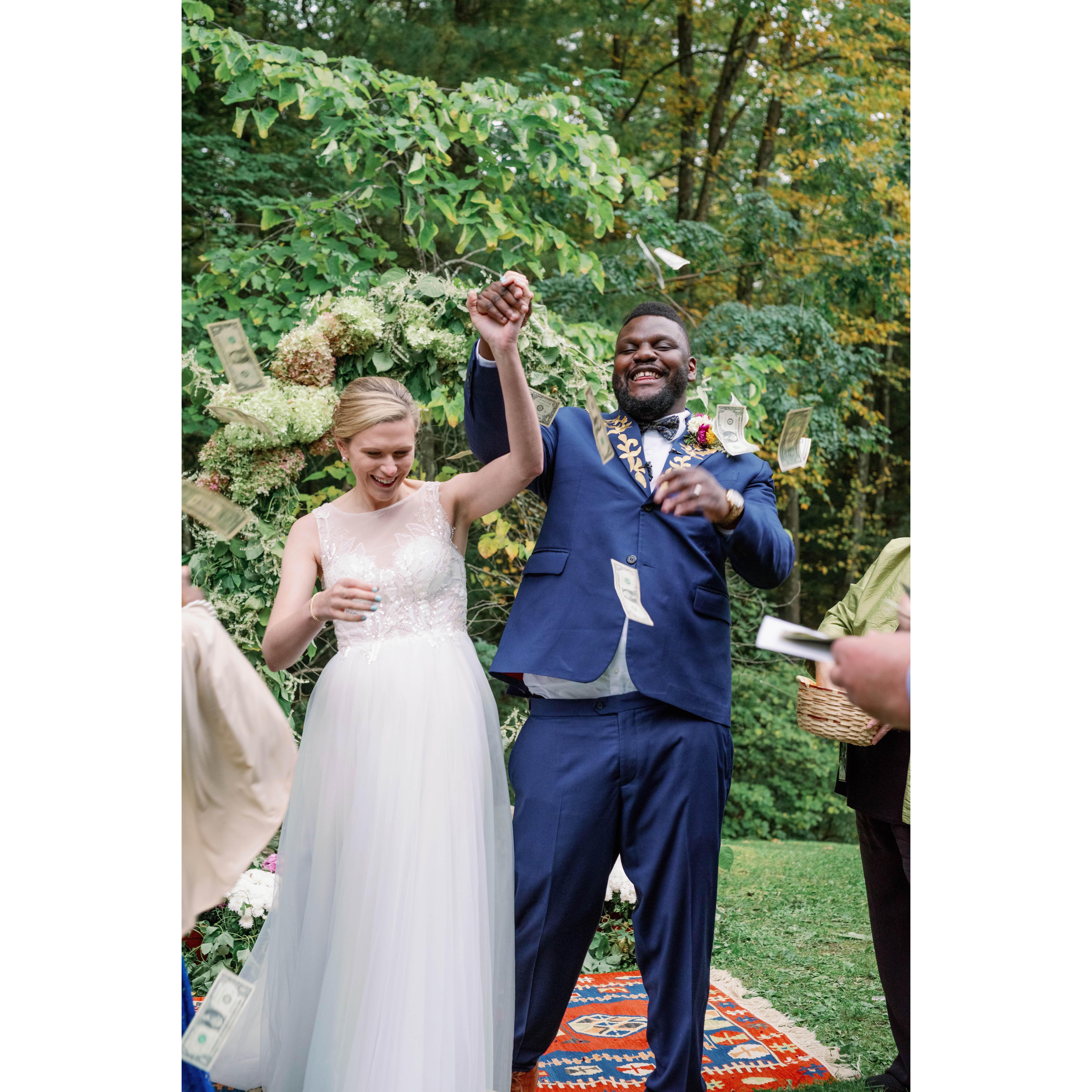 In Nigerian wedding tradition, we walked off into a flurry of money for good luck and prosperity