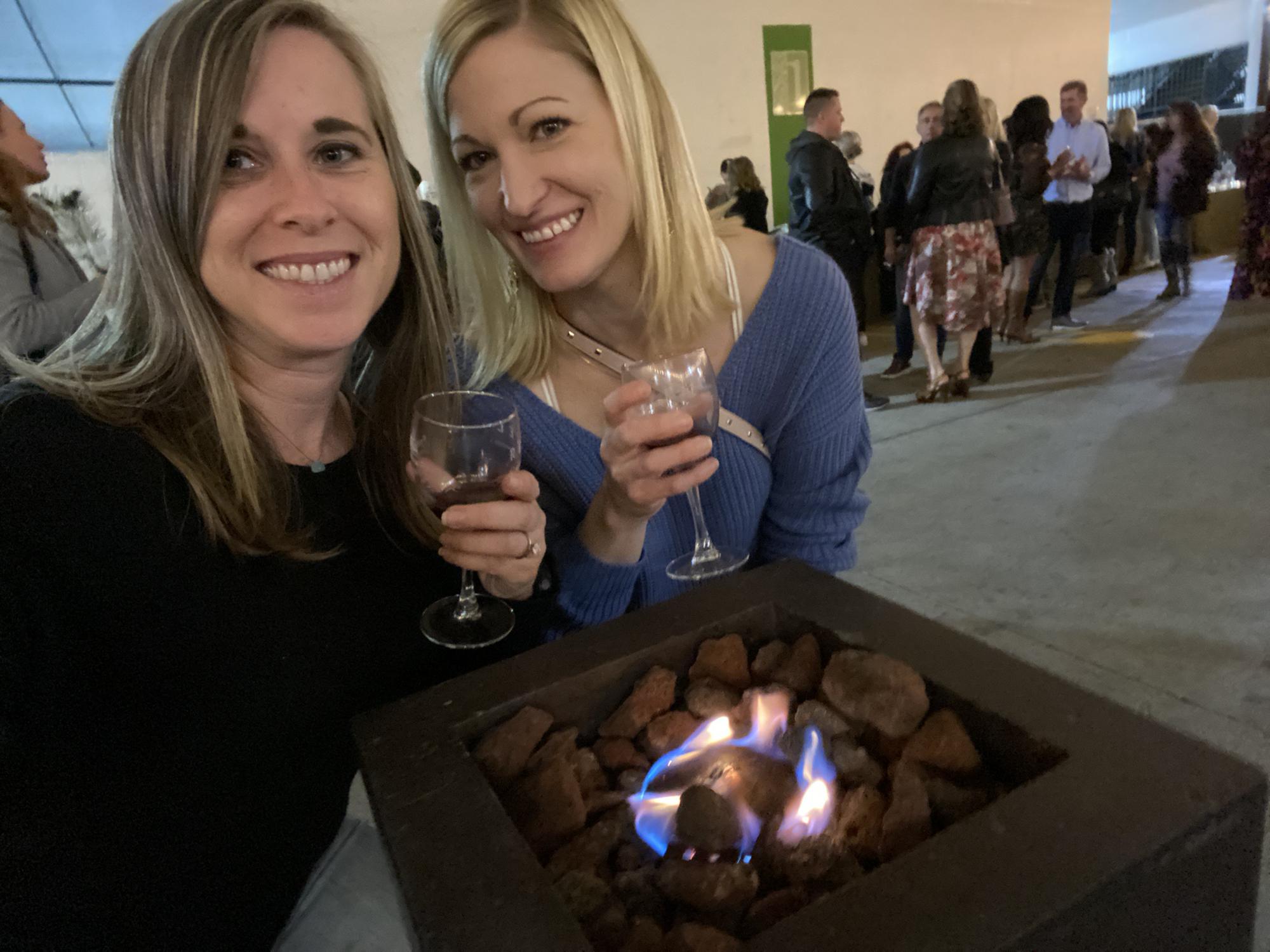 Caeli and Hillary hanging out by the smallest fire pit known to man, and of course drinking wine!