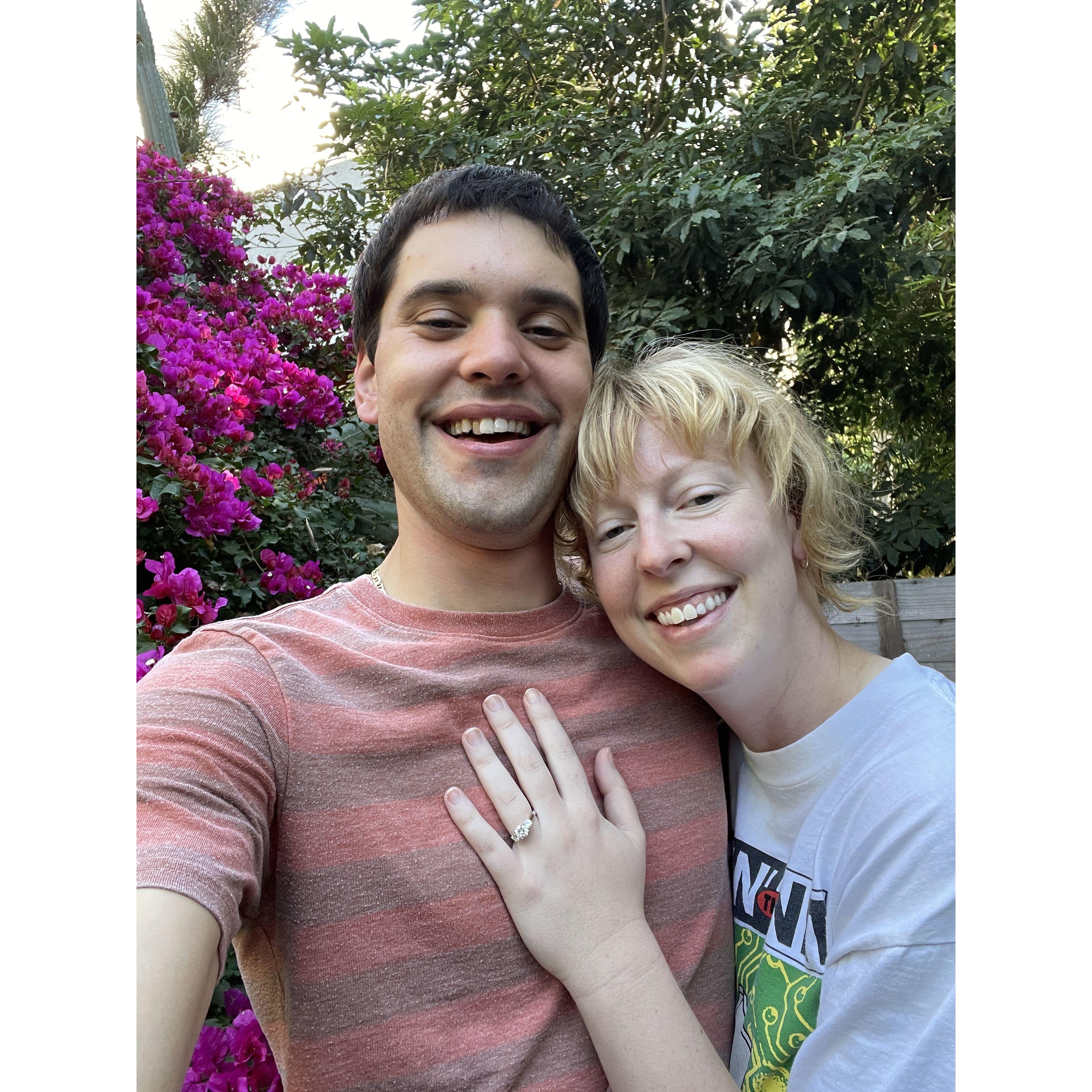 In our backyard, immediately after getting engaged. Our eyes are puffy because they're filled with joy!!!