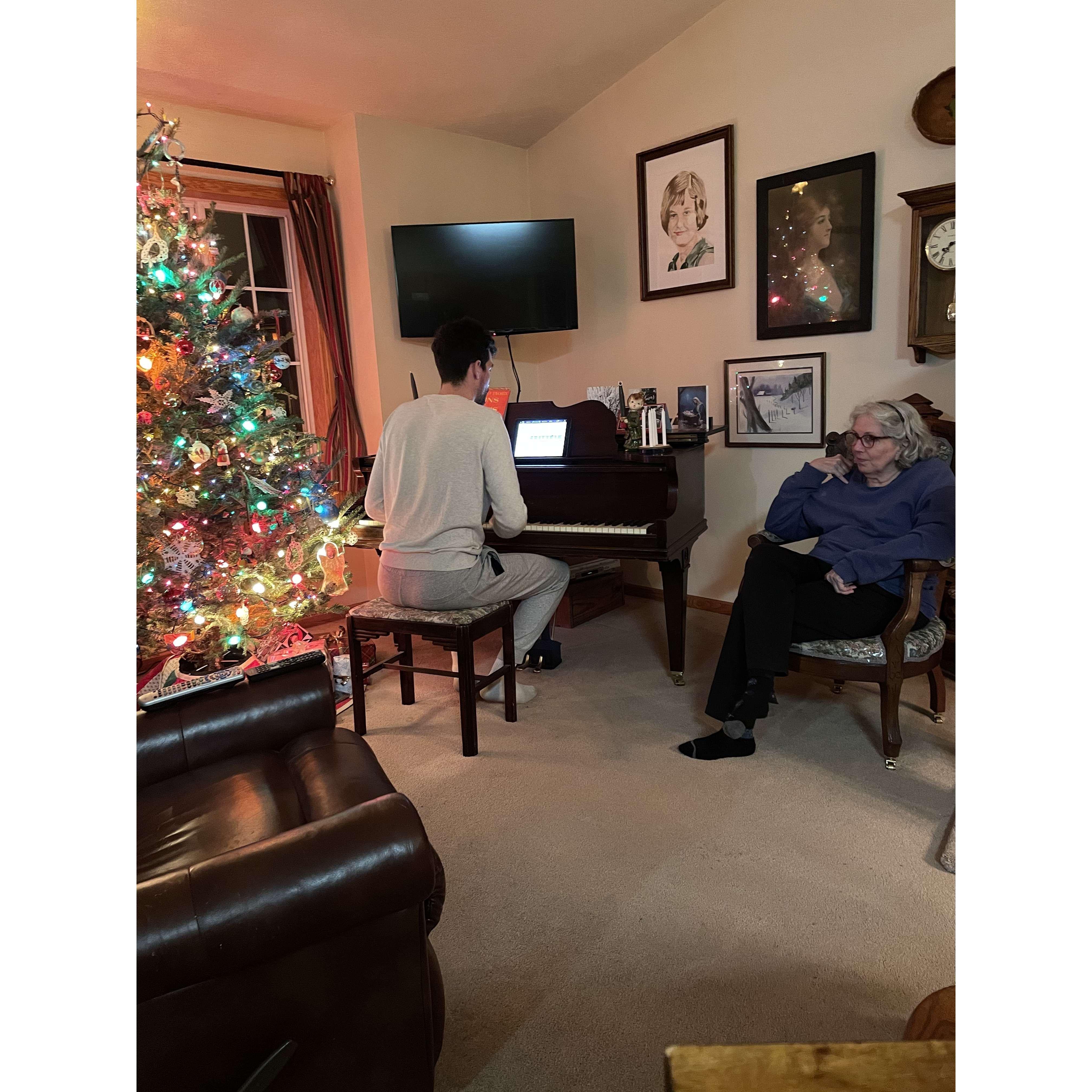 Joe playing piano with his mom, Becky, on Christmas