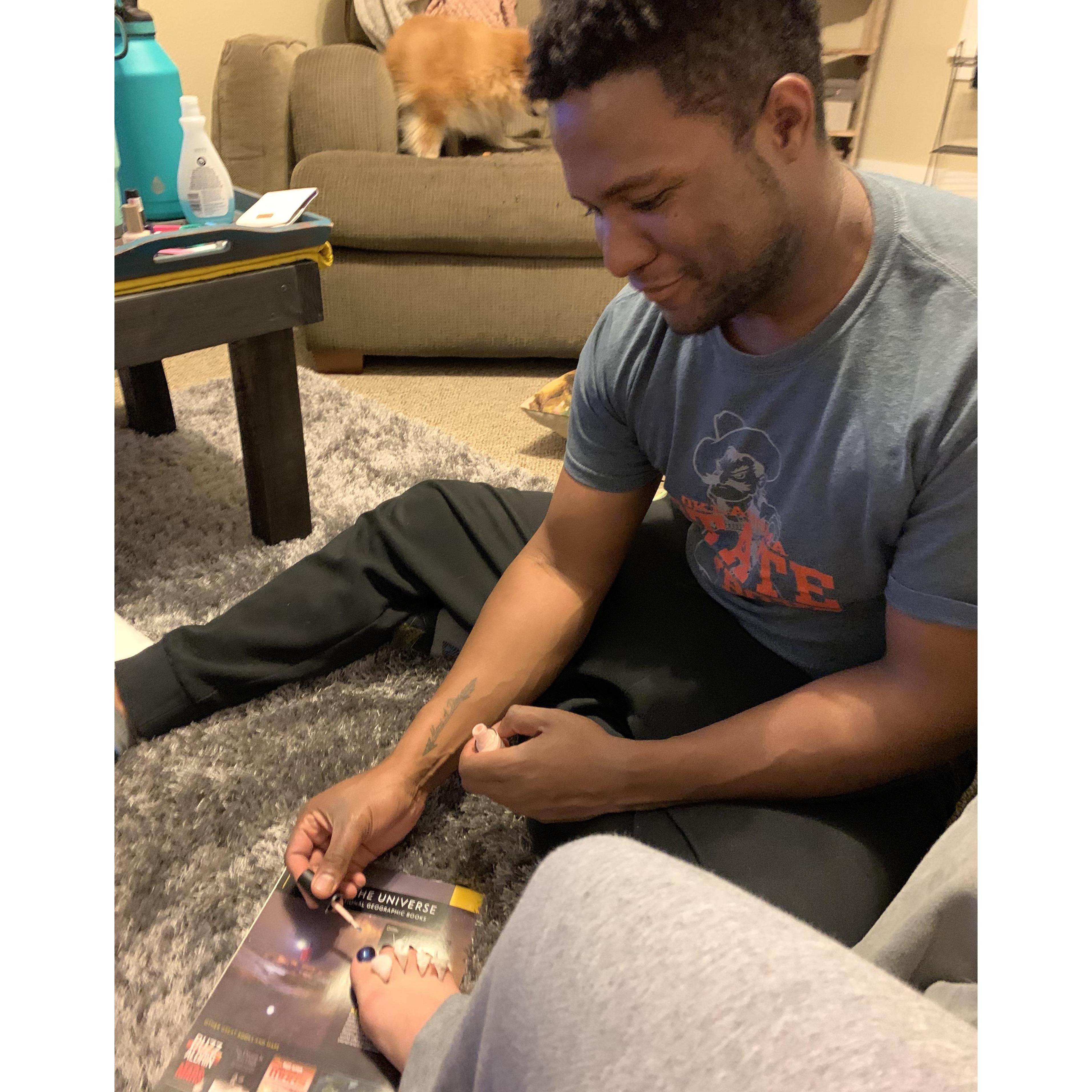 Sweet, sweet man painting Megan's toes.