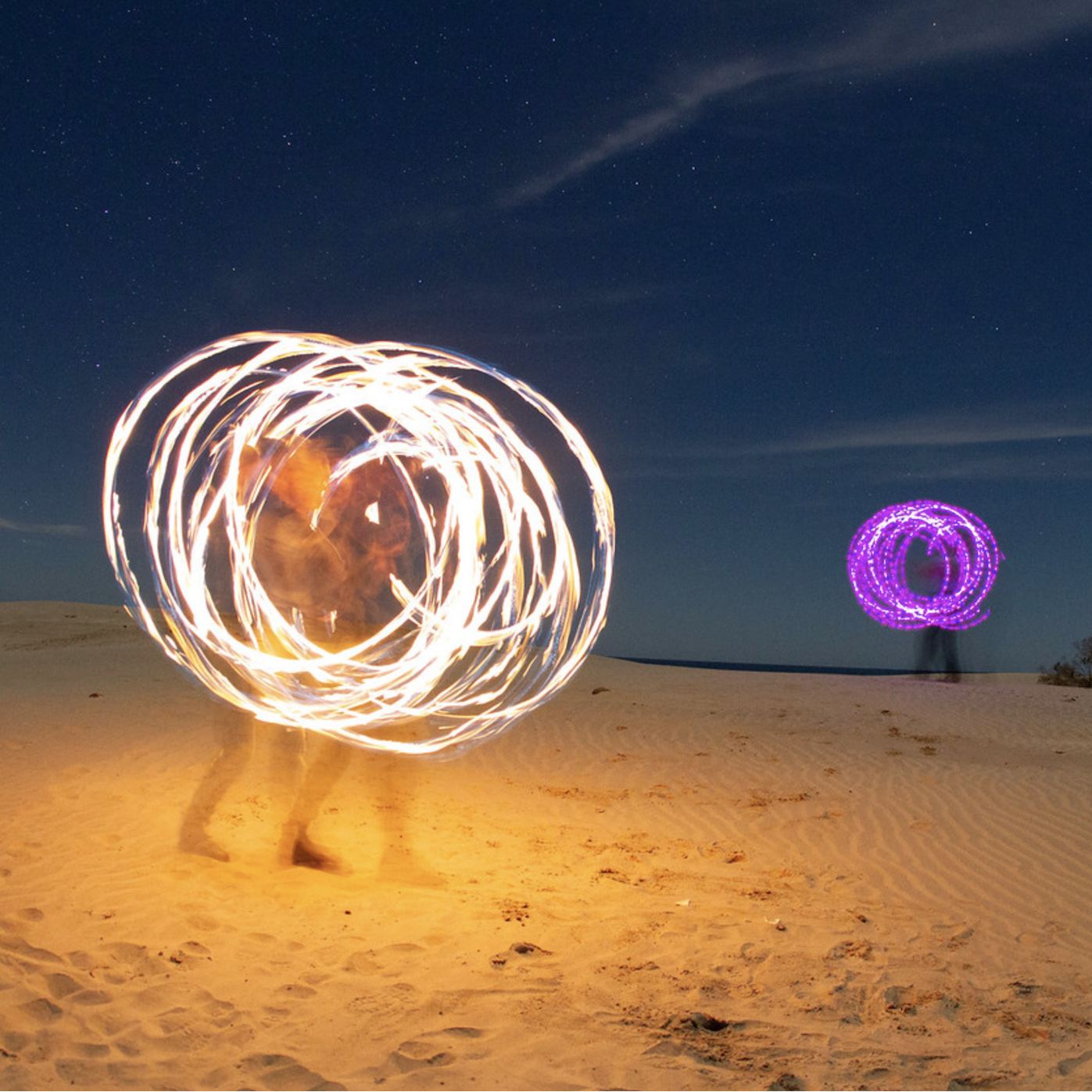 Hannah & Miranda dancing with fire in Baja