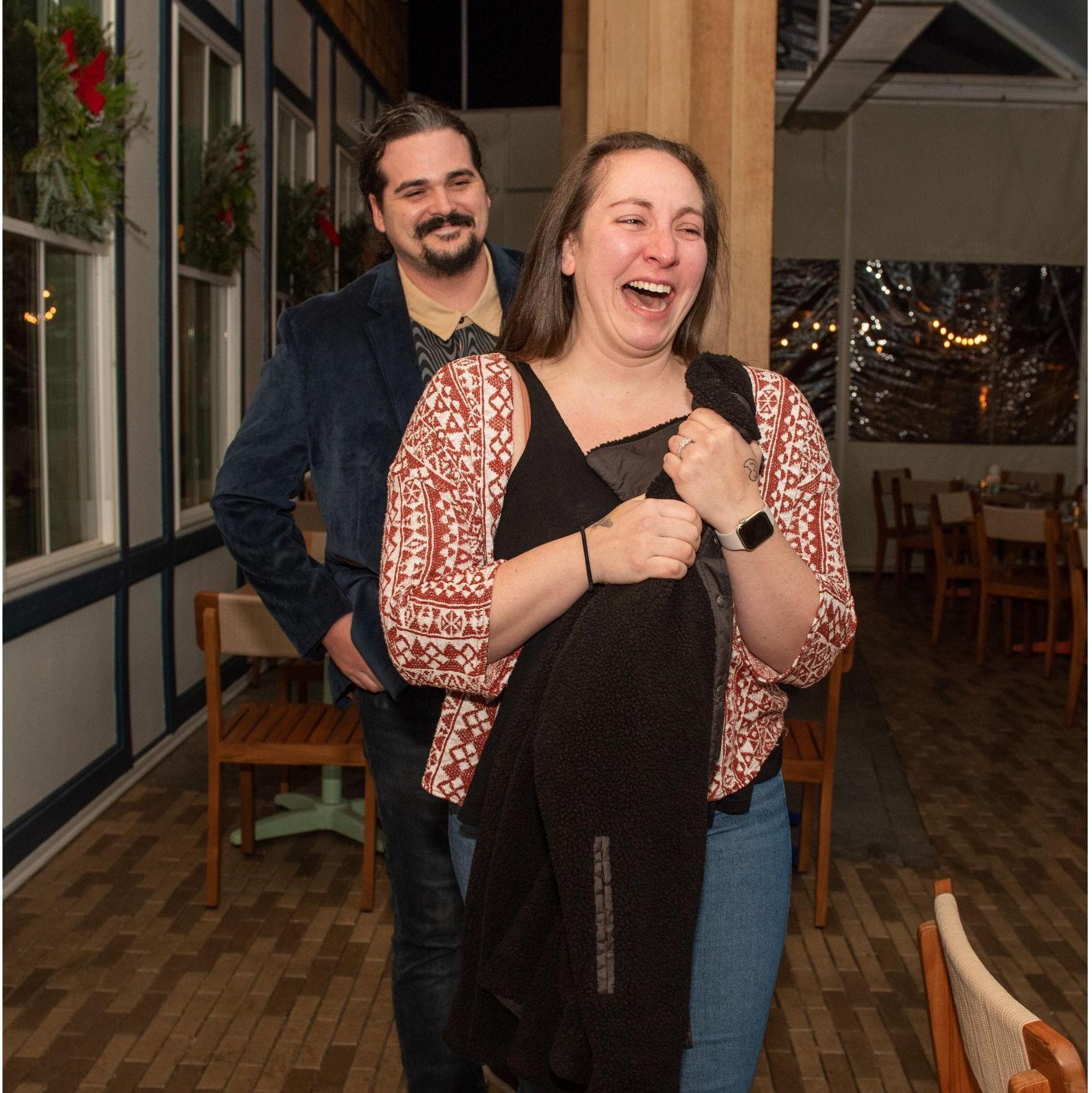 Katherine surprised by the friends and family gathered for dinner after Aymeric proposed