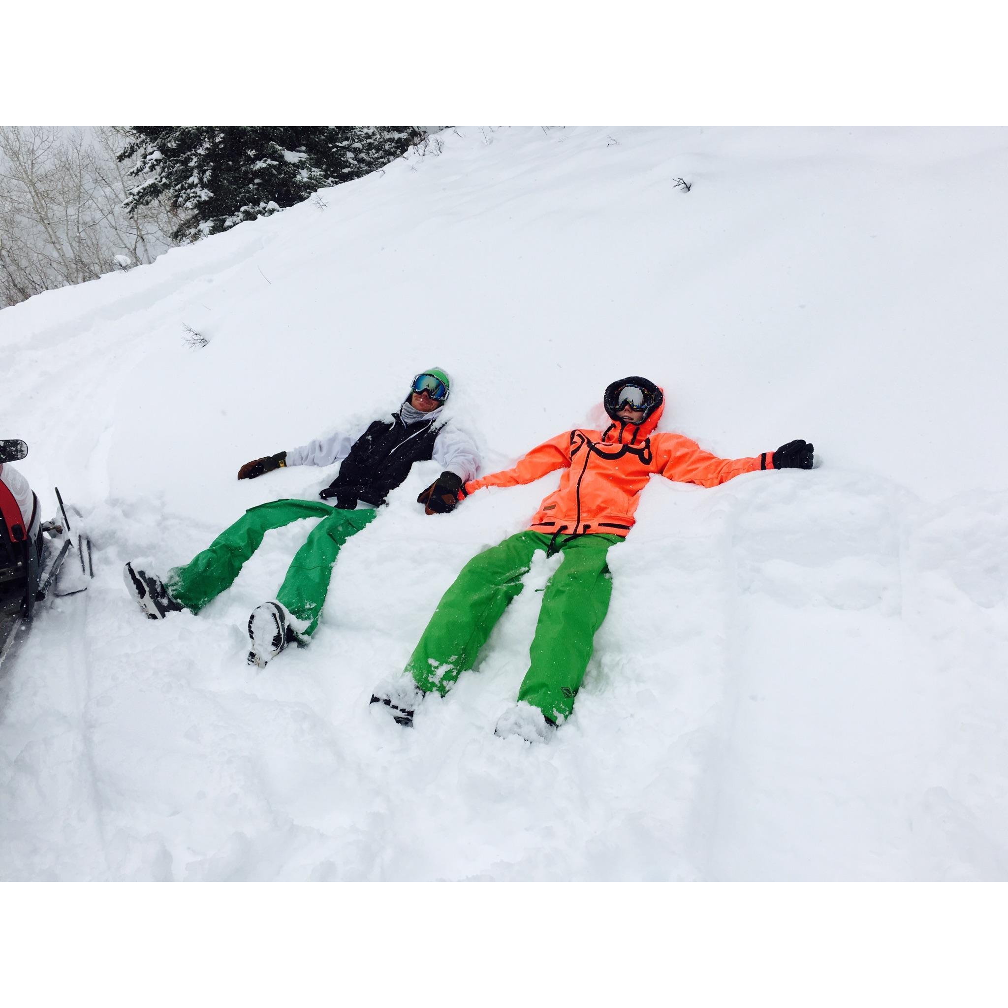 Our first get-a-way! Us taking a break in the snow after snowmobiling with great friends.