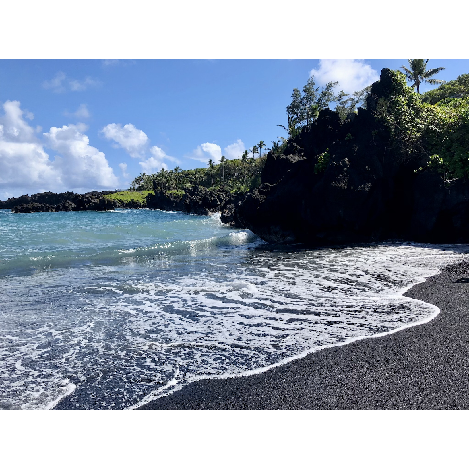 A black sand beach at Wai'anapanapa State Park, one of our stops on the road to Hana. We brought our bathing suits and went for a quick swim!