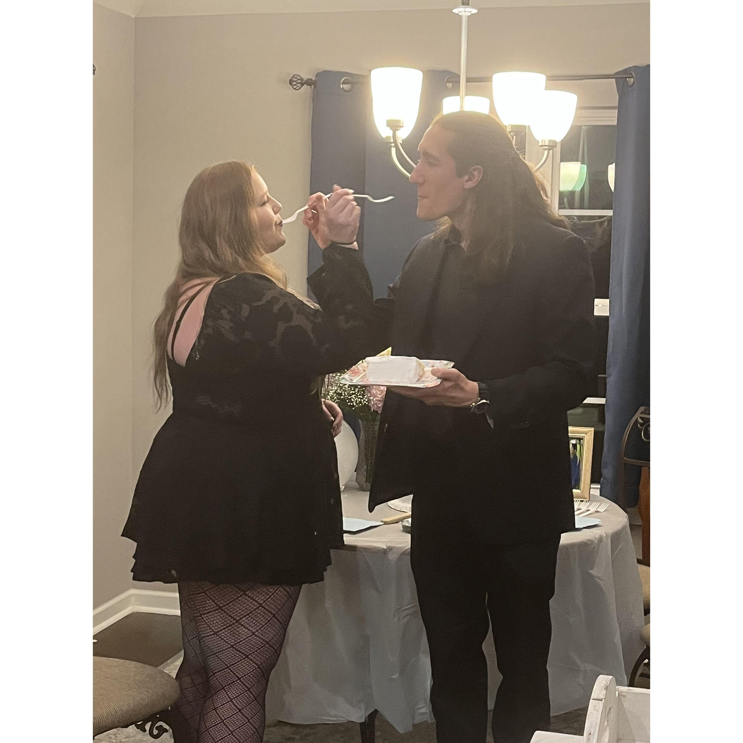 After we got engaged, we had some family and friends gathered at the house. Here we are eating cake together.