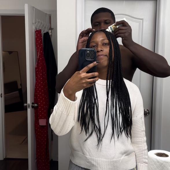 Mitchell helping Natasha maintain her braids