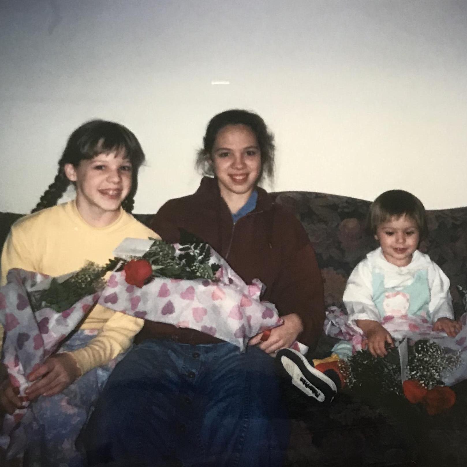 L to R: Sisters Rachel, Laura, 3 year old Annie with valentines day flowers from dad!