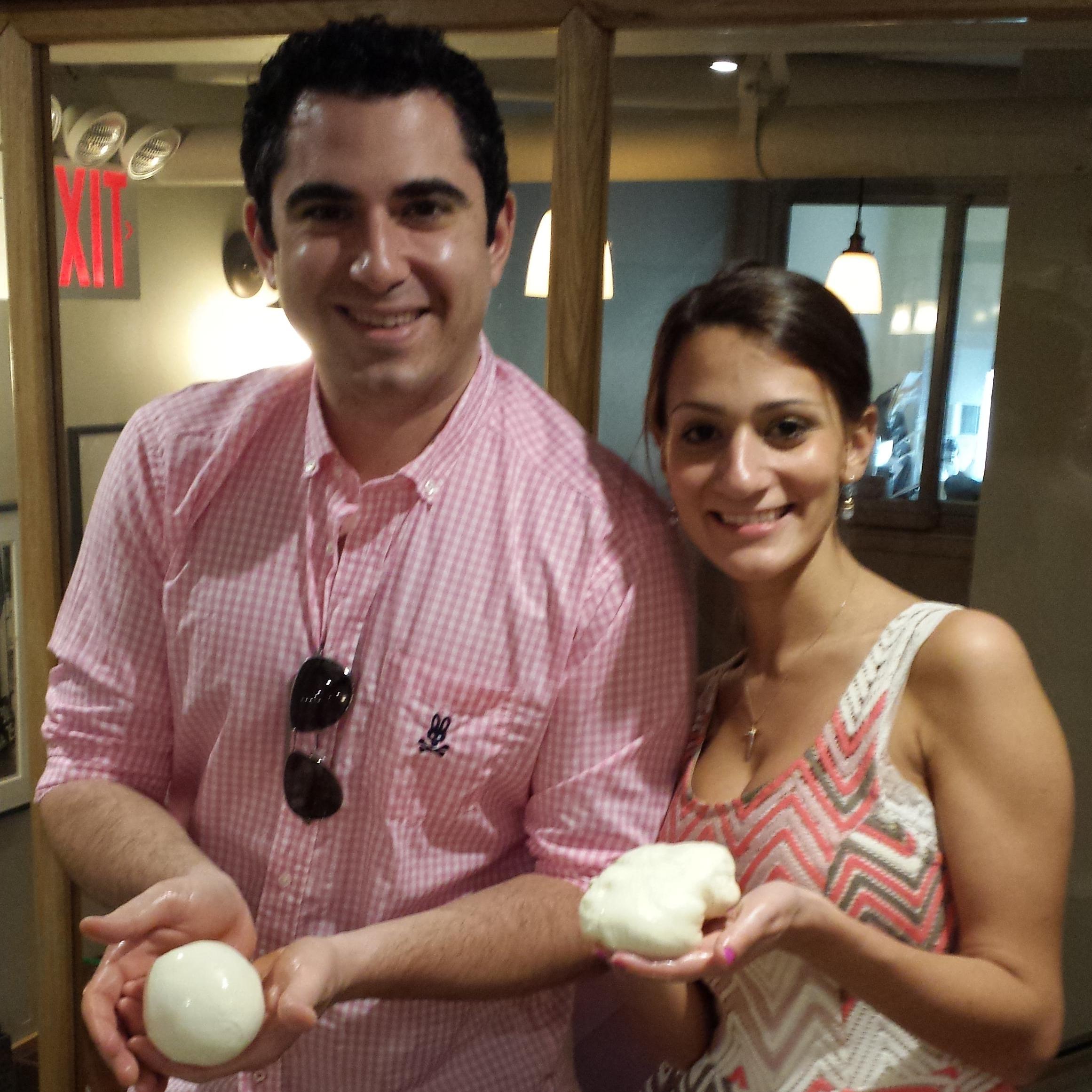 our first picture - after a mozzarella making class. we can clearly see who has the superior mozzarella!