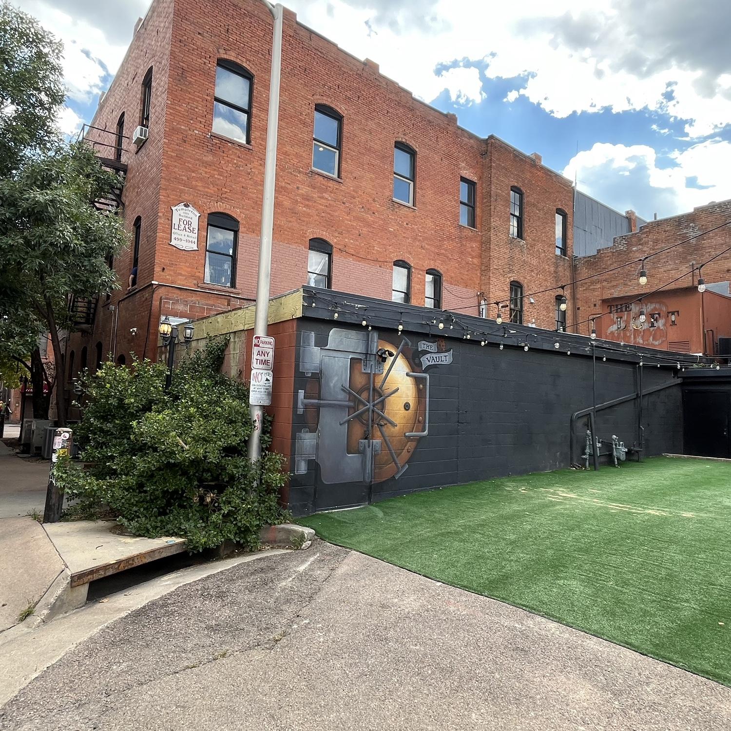 When you arrive for cocktail hour, go to the back of the venue. 25th street (between pikes peak and Colorado Ave) you will see an alley next RootBound Salon. The Vault will be on your left (pictured.)
