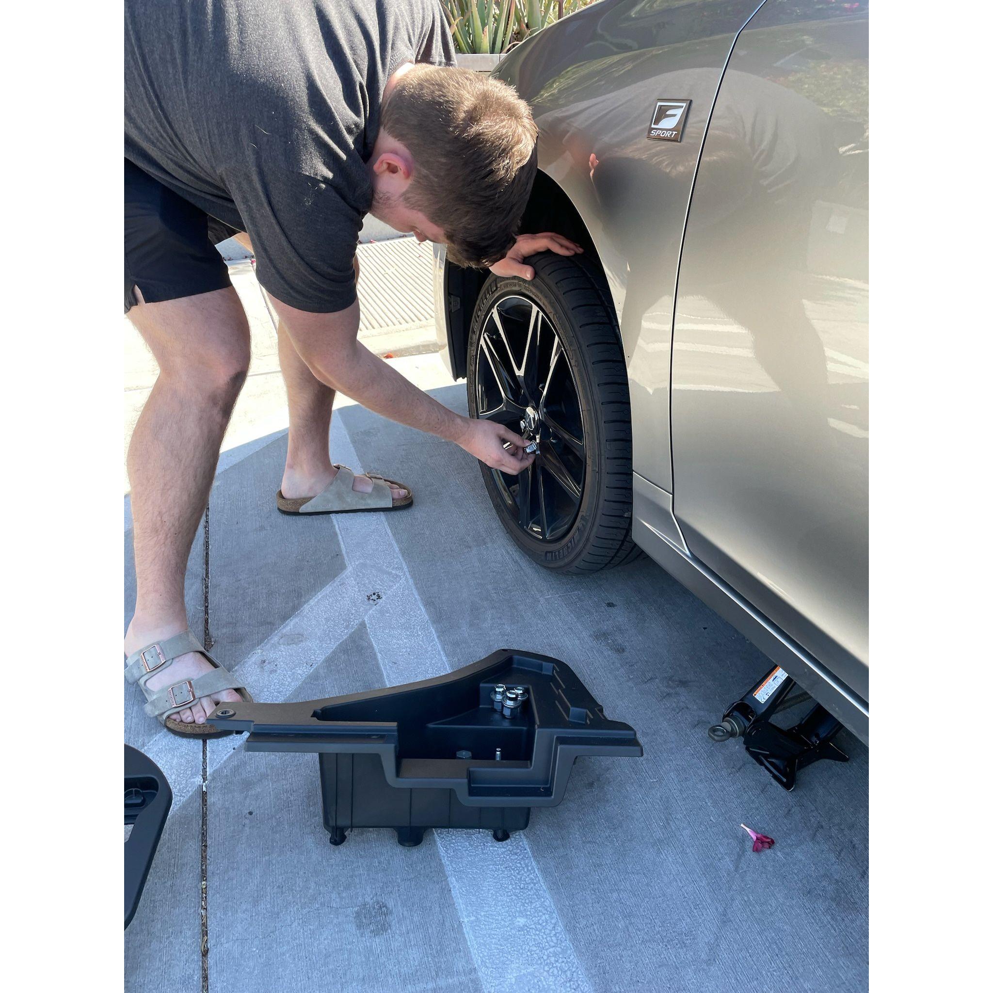 Don changing Regan's flat tire (it was a nail!)
